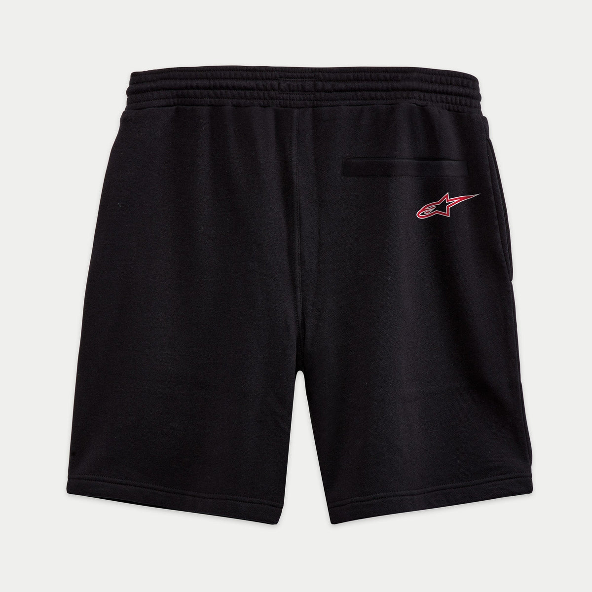 Alpinestars Dunker Short, short de entrenamiento de forro polar en color negro, vista posterior con cintura elástica, bolsillo trasero de ribete y logotipo Ageless rojo y blanco en la cadera.