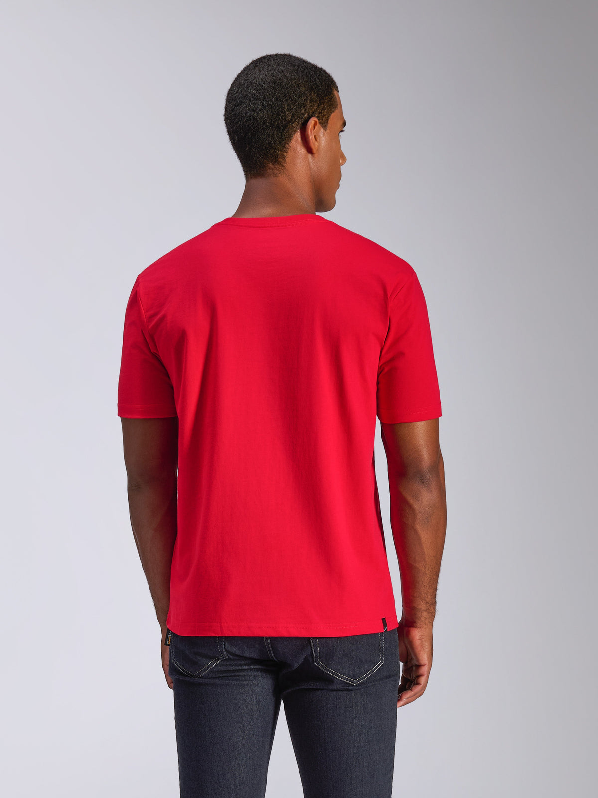 Alpinestars CSF Tee, camiseta de manga corta, roja, vista trasera, combinada con vaqueros oscuros, ropa de calle casual de estilo motorsport