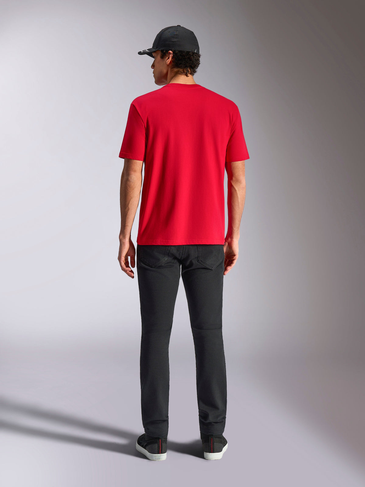 Alpinestars Noka CSF Tee, Short Sleeve T-Shirt, Red, back view, styled with black pants and a black baseball cap, casual motorsport-inspired streetwear