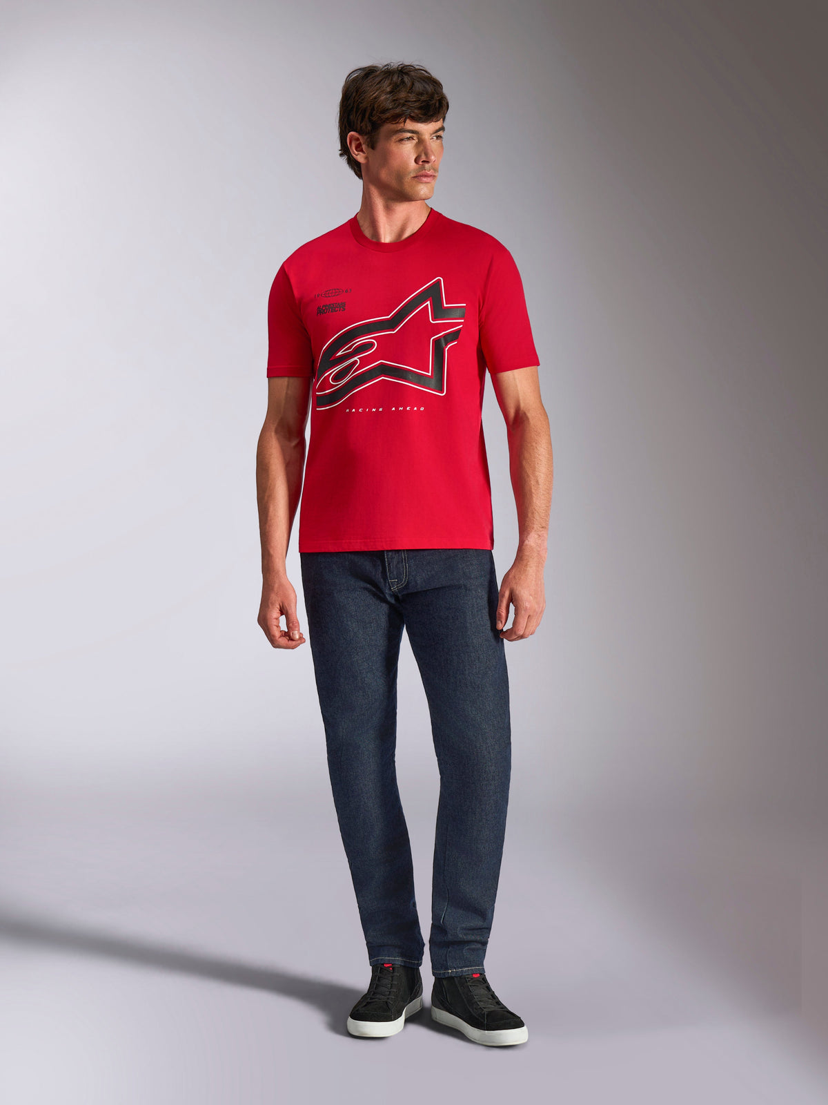 Alpinestars Authority CSF Tee, Short Sleeve T-Shirt, Red, Large Black Cropped Astars Logo with White Outline, worn with dark blue jeans and black sneakers, casual motorsport-inspired streetwear