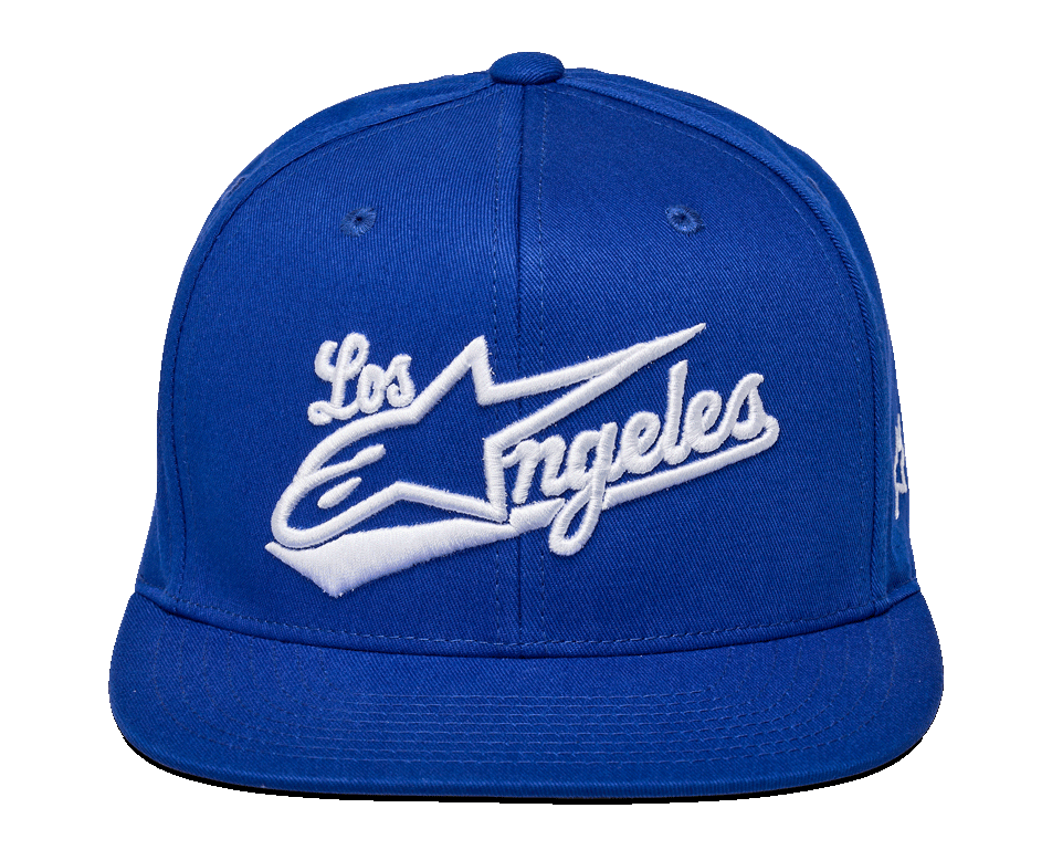 Gorra Alpinestars Los Angeles, gorra snapback azul, bordado 3D blanco con fuente atlética 'Los Angeles' y logotipo Ageless, corona estructurada, visera plana, estilo deportivo casual y urbano