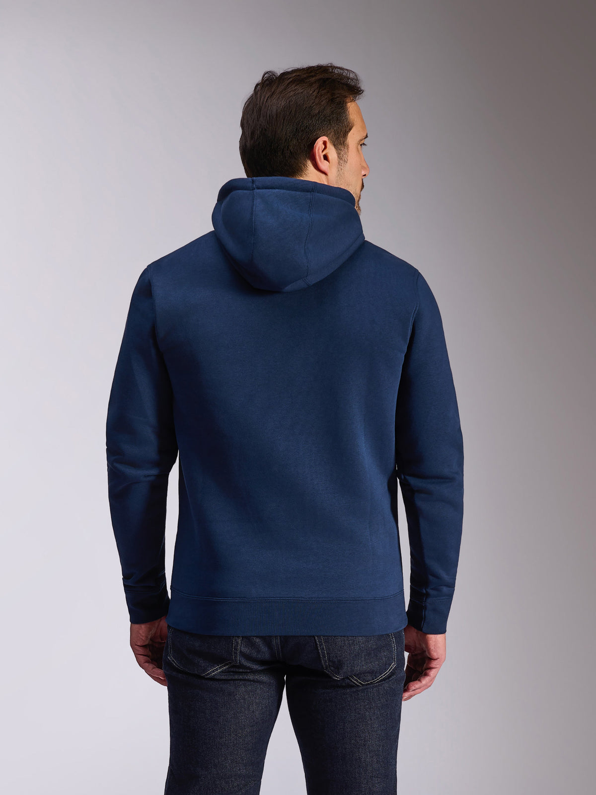Alpinestars Ride V3 Hoodie, navy blue pullover fleece, back view showing solid blue design with jersey-lined hood, rib-knit cuffs and hem, casual motorsport streetwear