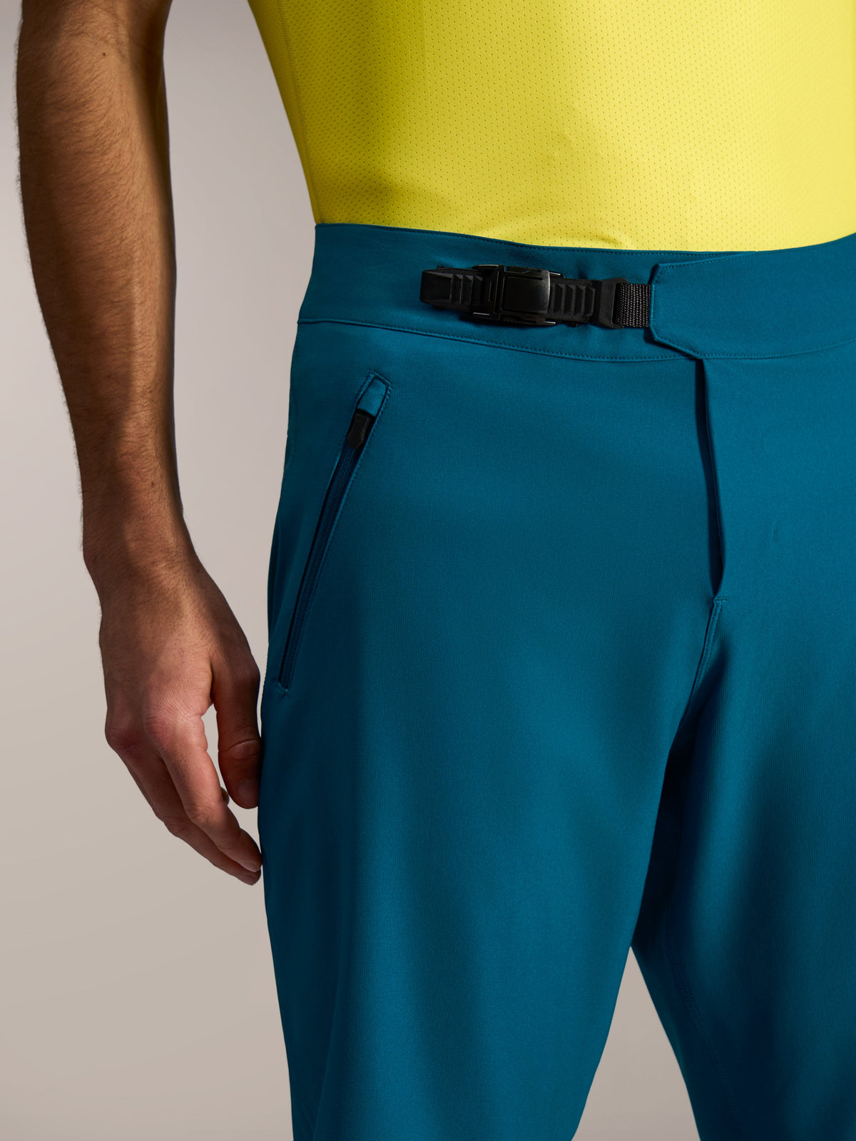 A-Dura Ride MTB Shorts in blue green, featuring a precise ratchet waist closure and secure zippered side pockets.