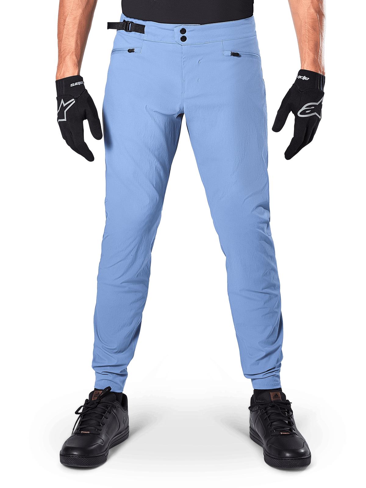 Alpinestars A-Dura Pants, MTB Pants, Infinity Blue, light blue mountain bike trousers featuring double snap closure and zippered pockets, worn with black gloves and black shoes, regular fit with elasticated cuffs