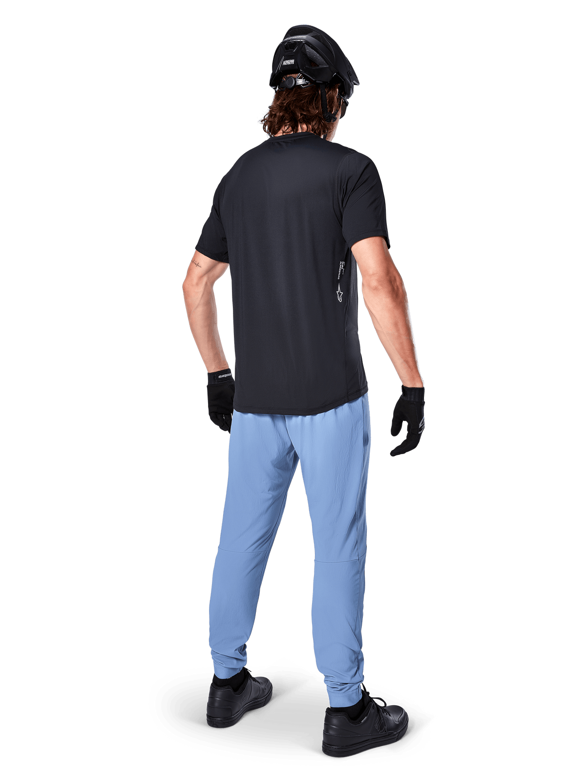 Alpinestars A-Dura Pants, MTB Pants, Infinity Blue, rear view on model wearing a black t-shirt and black cycling helmet, featuring durable 2-way stretch fabric and elasticated cuffs, performance gear for mountain biking
