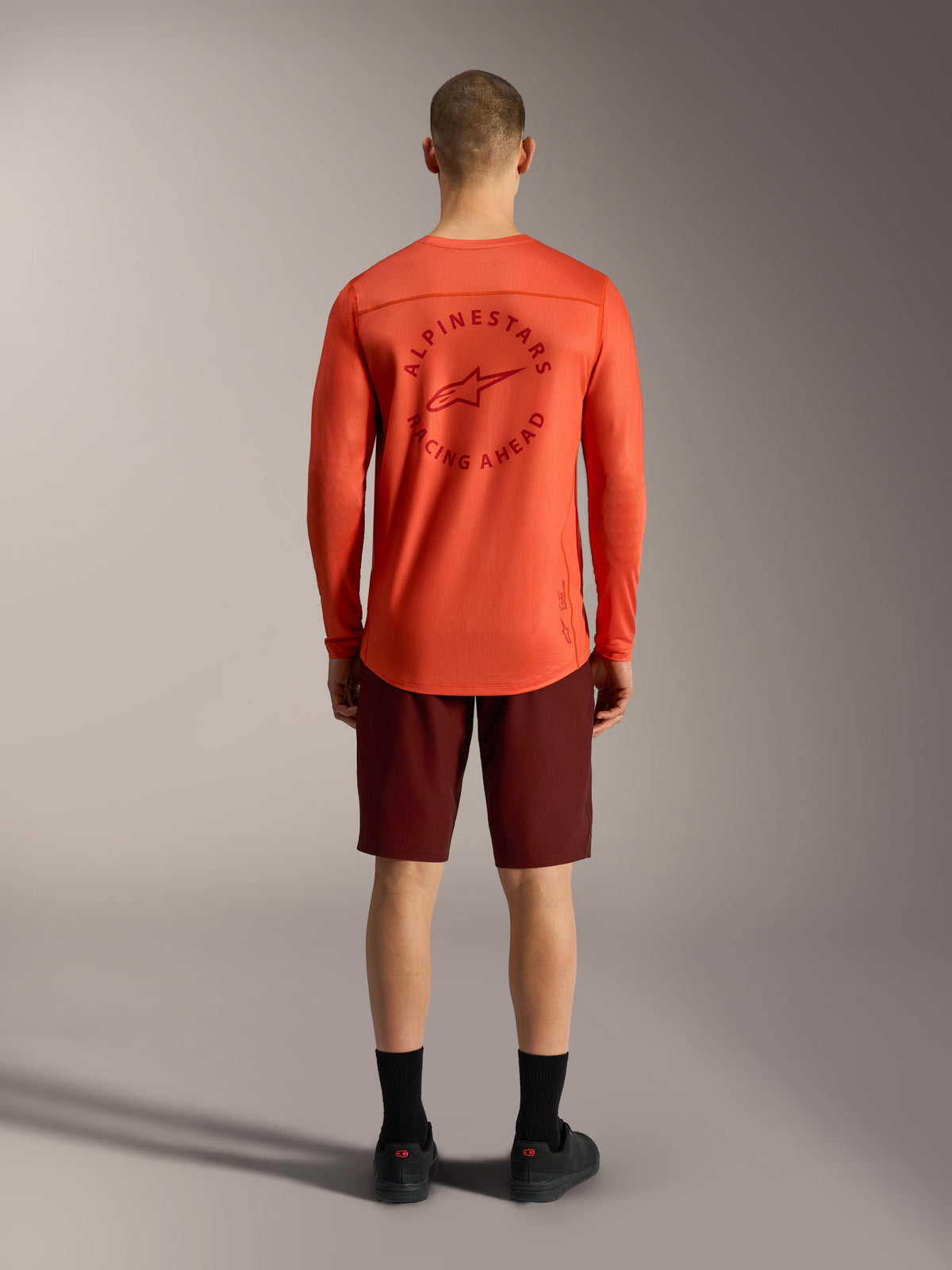 Orange A-Dura Air LS Jersey paired with Bordeaux Ride Shorts, rear view of performance Alpinestars MTB apparel.