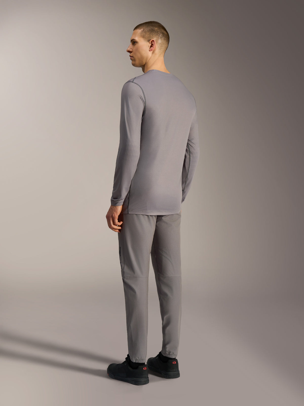 Camiseta A-Dura Ride gris de manga larga con patrón de camuflaje tonal y tejido elástico, vista desde la espalda.
