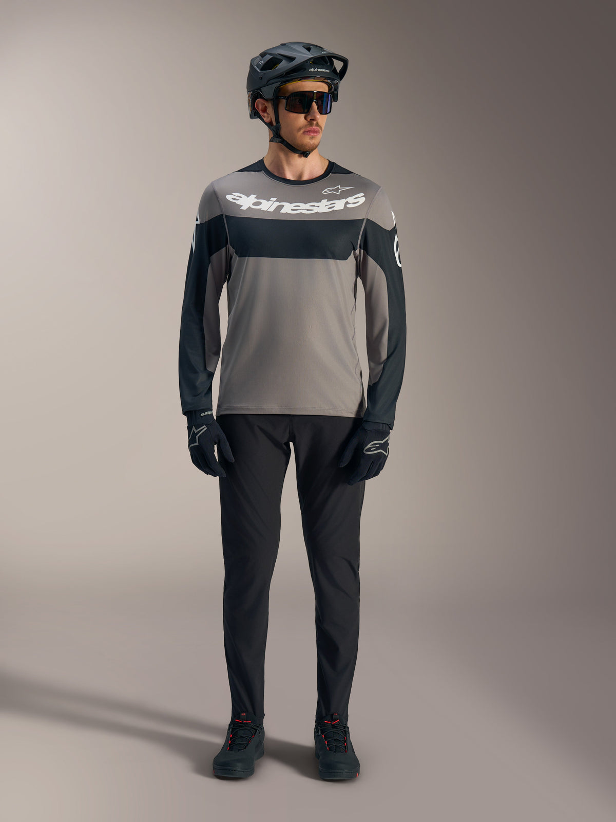 A-Dura Race Long Sleeve Jersey in gray and black with white Alpinestars logo, styled with performance MTB gear.