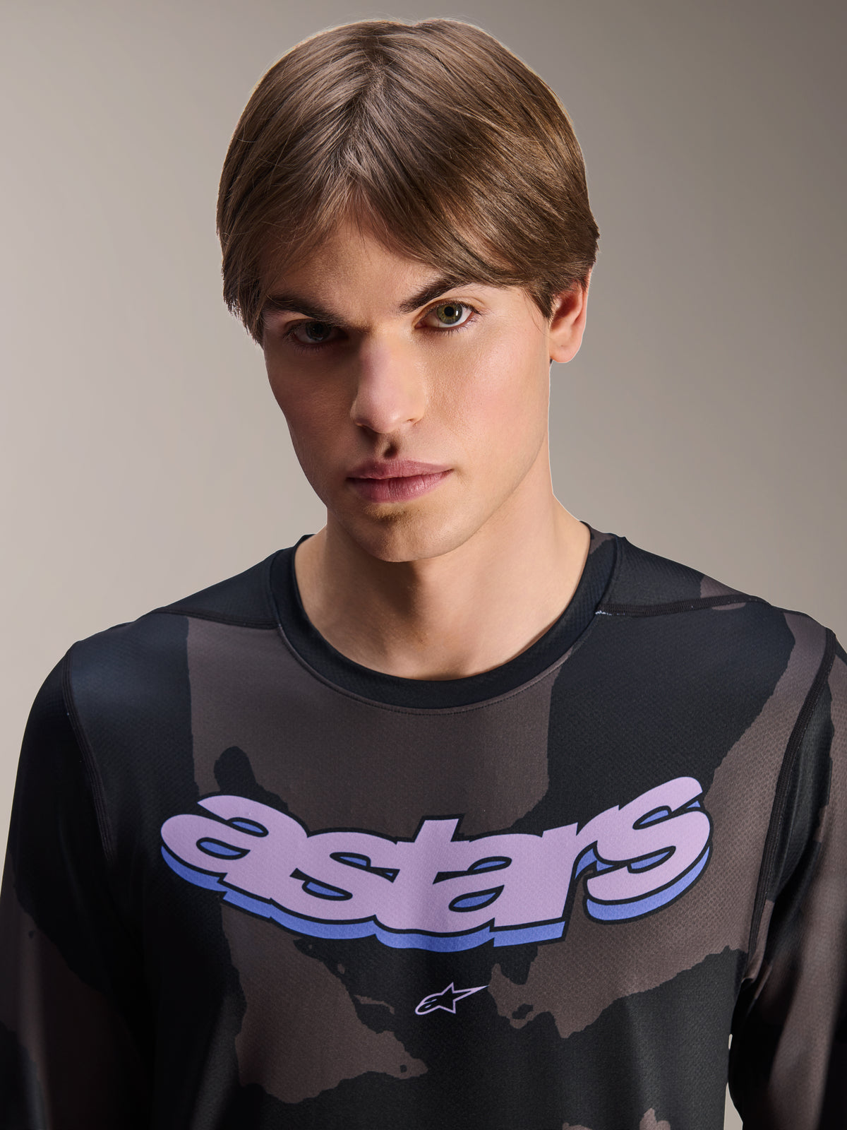 Alpinestars A-Dura Hollow Camo Jersey - Long Sleeve, Black Camo with purple 'astars' chest graphic, studio shot of male model wearing MTB apparel, casual and technical mountain bike style