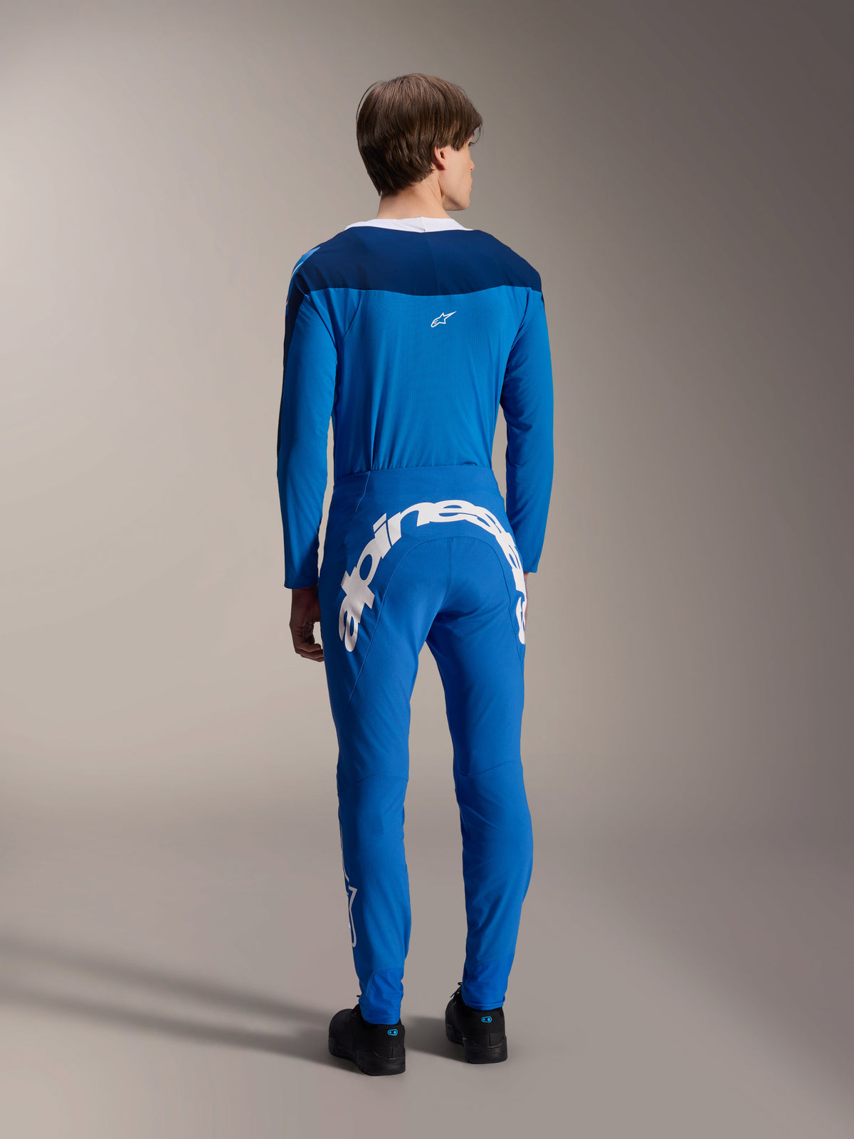 Alpinestars A-Supra Melt Pants and matching Long Sleeve Jersey, Blue, back view highlighting the large white Alpinestars wordmark on the rear yoke, performance MTB gear with a flexible athletic fit