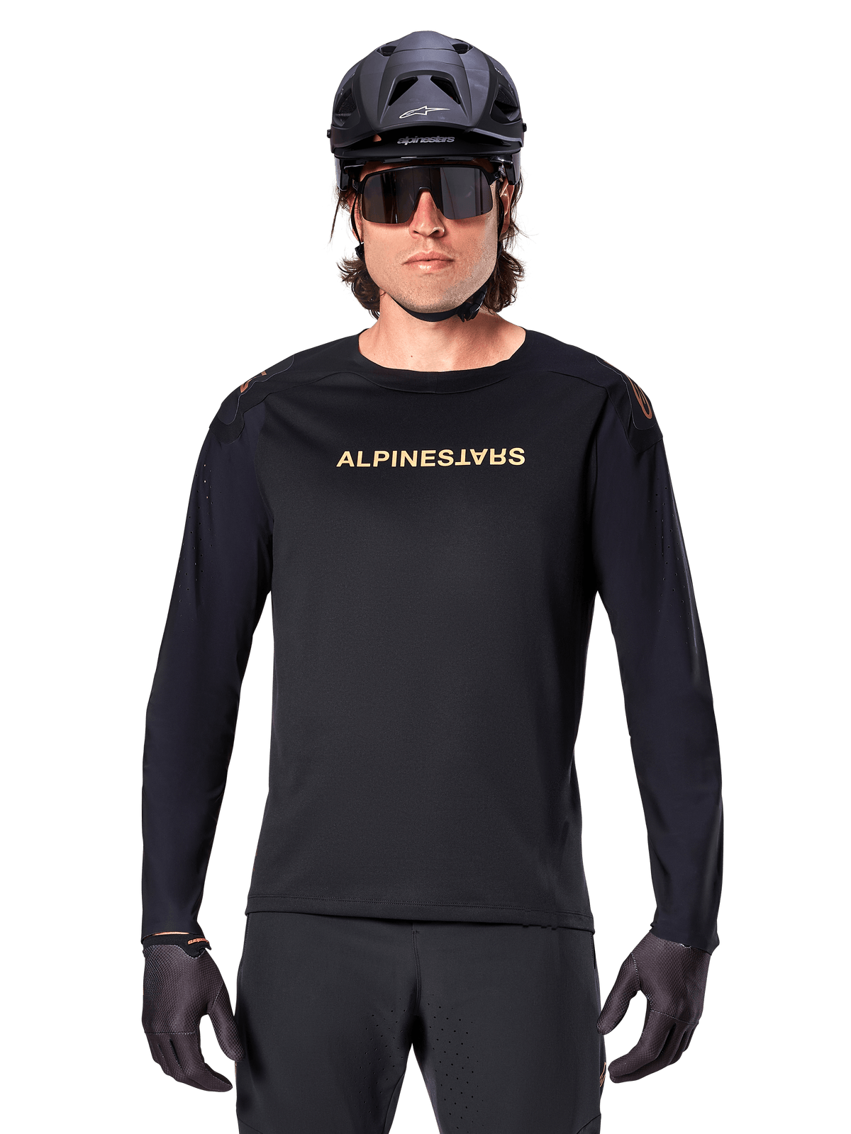 Alpinestars A-Aria Polartec Switch Long Sleeve Jersey, Black, gold Alpinestars logo on chest, worn with a black MTB helmet, dark sunglasses, and black gloves, professional mountain bike trail gear