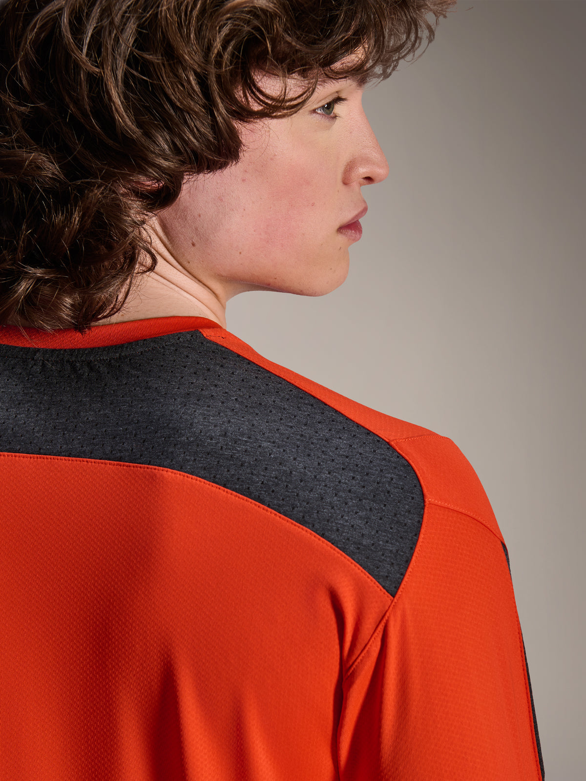 Alpinestars A-Dura Insert Astar Jersey, Long Sleeve MTB Jersey, Spicy Orange, featuring dark grey mesh panels on the shoulder and upper back, durable textile for off-road performance