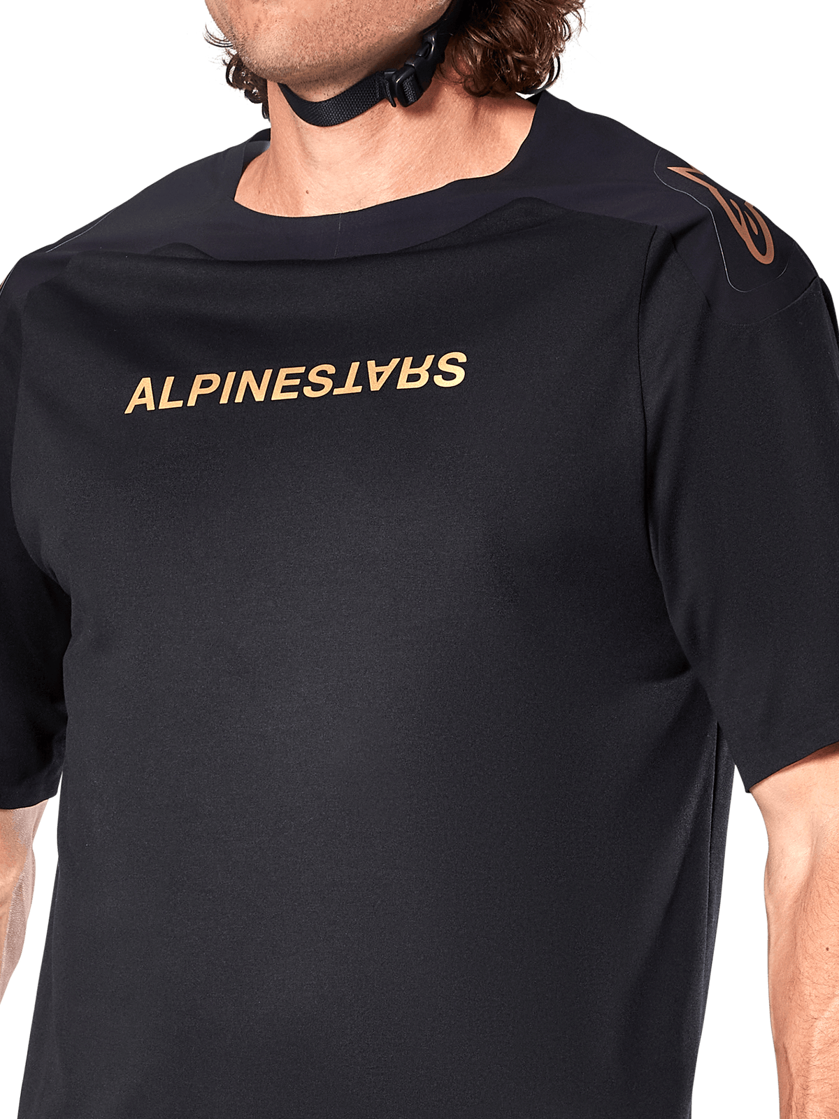 Alpinestars A-Aria Polartec Switch Jersey, Short Sleeve MTB Jersey, Black, Gold Alpinestars lettering on chest and logo on shoulder, close-up of the upper torso highlighting technical fabric and performance fit