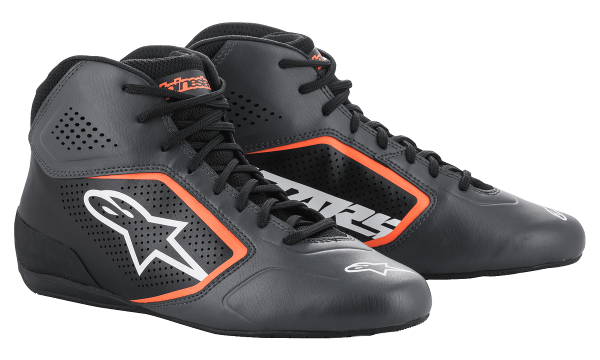 Zapatillas Alpinestars Tech-1 K Start V2, zapatillas de karting, color negro asfalto y naranja flúor, con parte superior de microfibra perforada, detalles en naranja brillante, logo Astar blanco en el lateral y un diseño de competición de perfil bajo