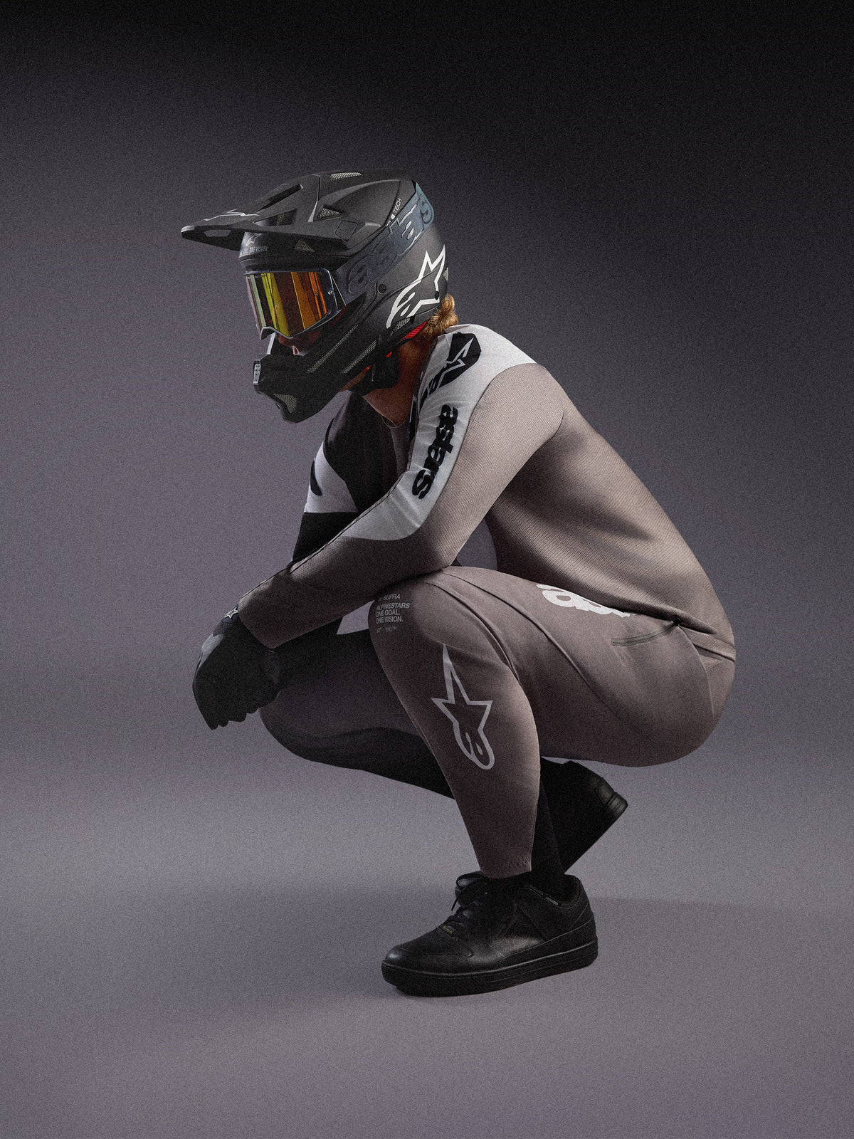 Maillot y pantalones MTB A-Supra Elite gris degradado, con casco integral negro y gafas para competición.
