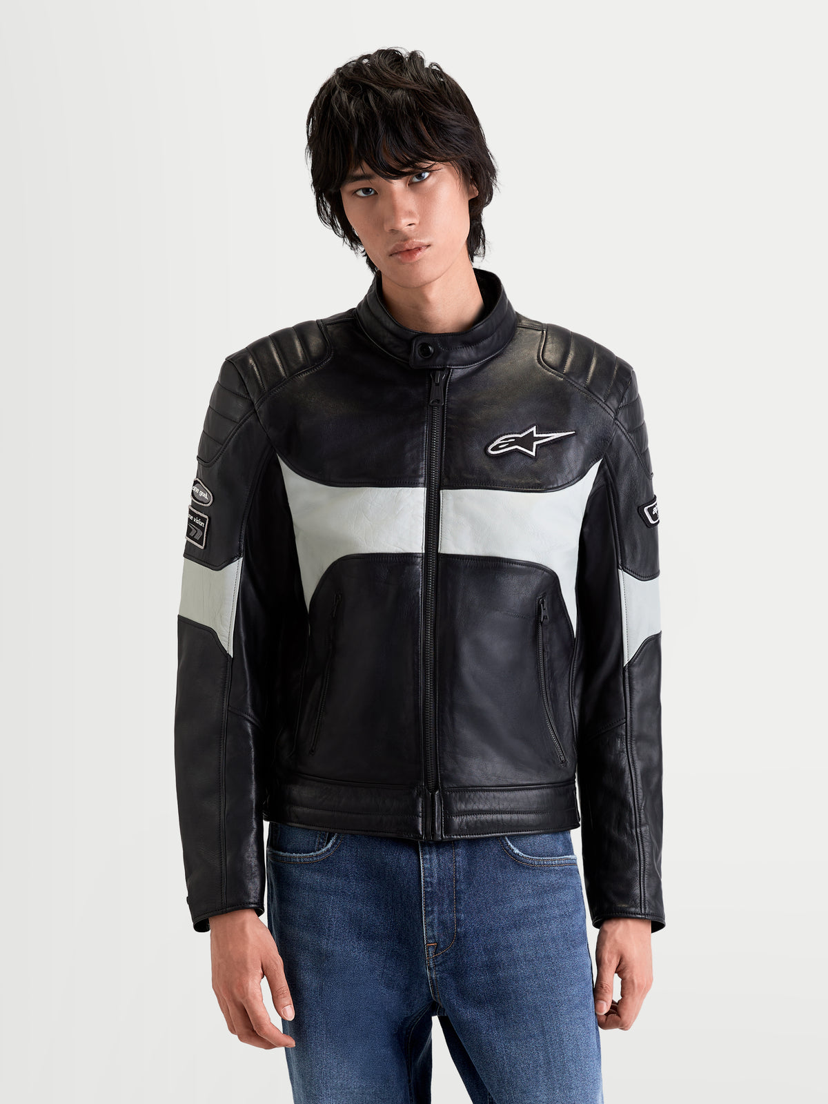 Alpinestars Revern Leather Jacket, men's urban contemporary motorcycle jacket in black and metal gray, front view worn by a model showing distressed full-grain bovine leather construction and heritage styling