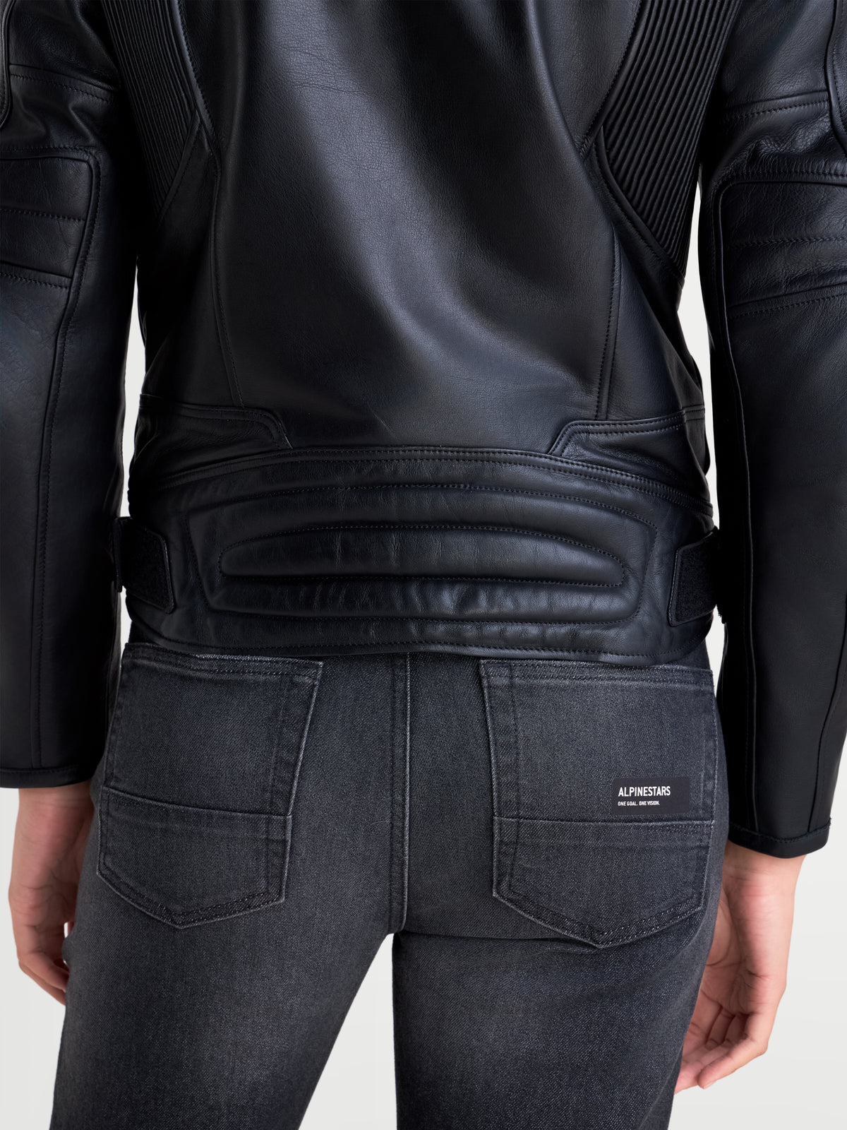 Alpinestars Revea Women Leather Jacket, women's urban motorcycle leather jacket in black, rear view showing full-grain leather construction and pleated shoulder panels worn by a model