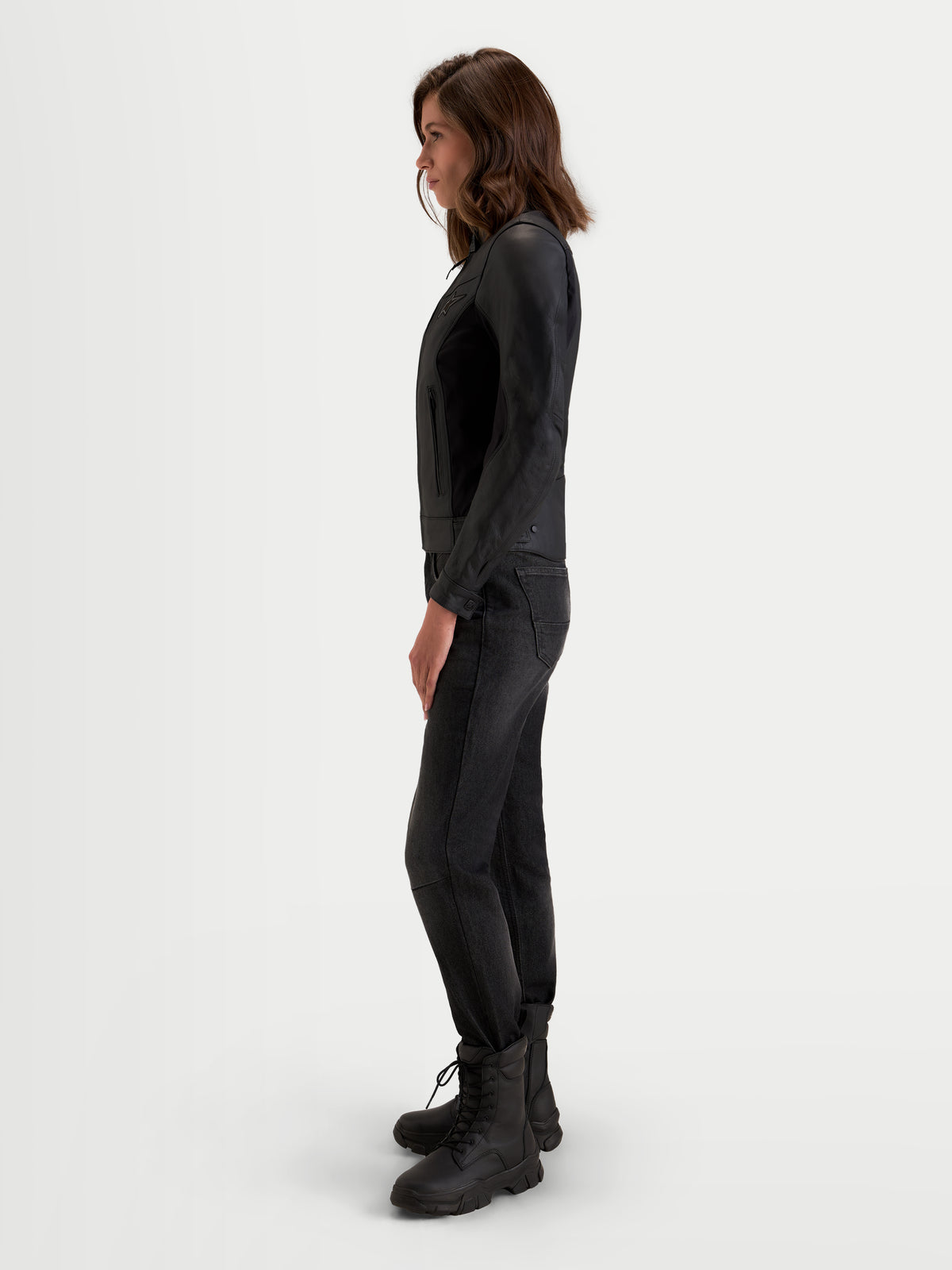Alpinestars Stella Maver-X Leather Jacket, women's urban contemporary motorcycle leather jacket in black, side profile view worn by a model showcasing premium bovine leather and tailored fit
