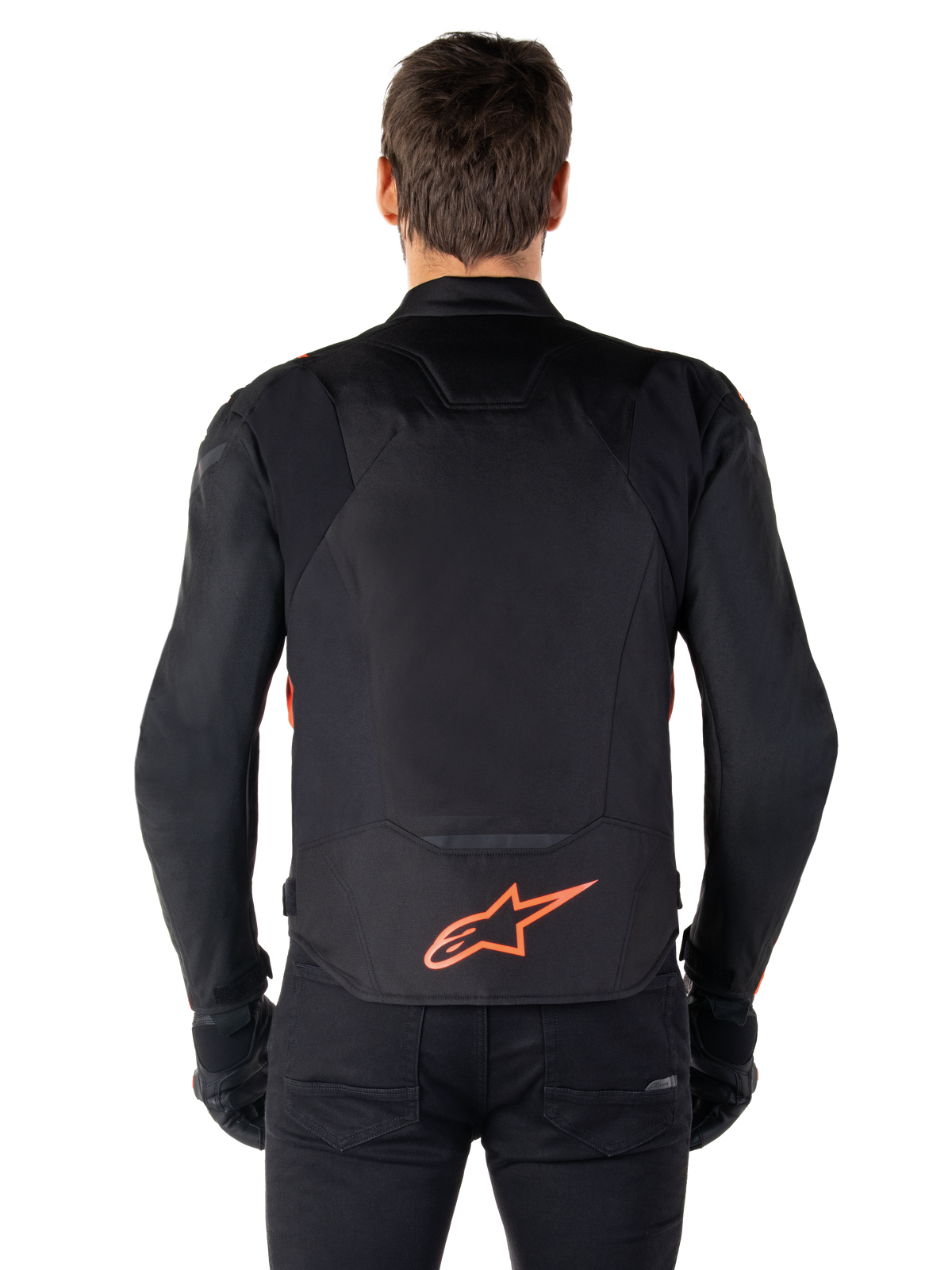 Alpinestars T-Jaws V4 Waterproof Jacket, Rear View, Black with Red Fluo, featuring a red Alpinestars logo on the lower back, technical textile construction, worn with black pants and gloves for a complete sport riding look