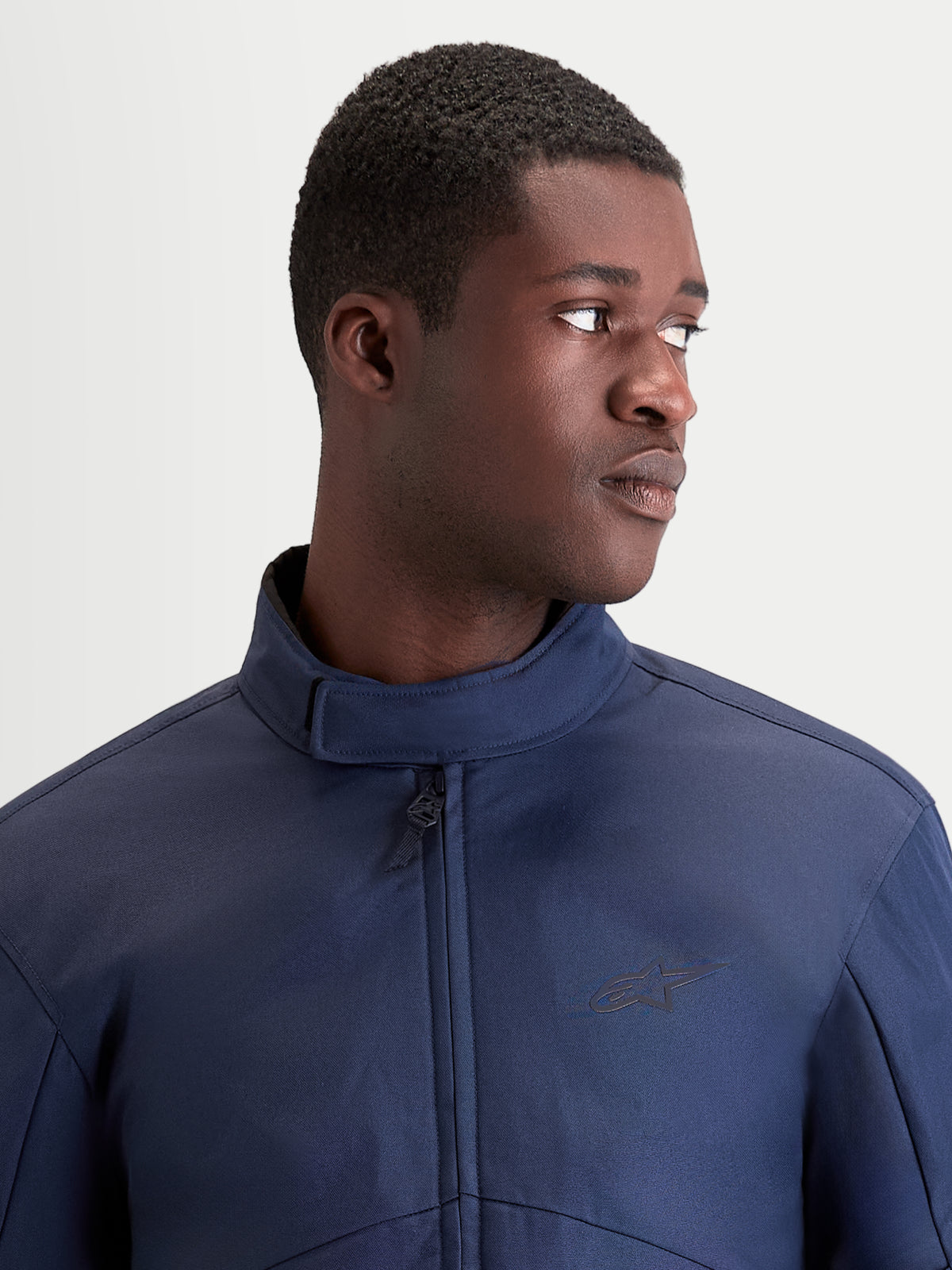 Alpinestars C-1 Waterproof Jacket, men's urban contemporary motorcycle textile jacket in dark blue, close-up view showing ergonomic collar and waterproof construction worn by a model.