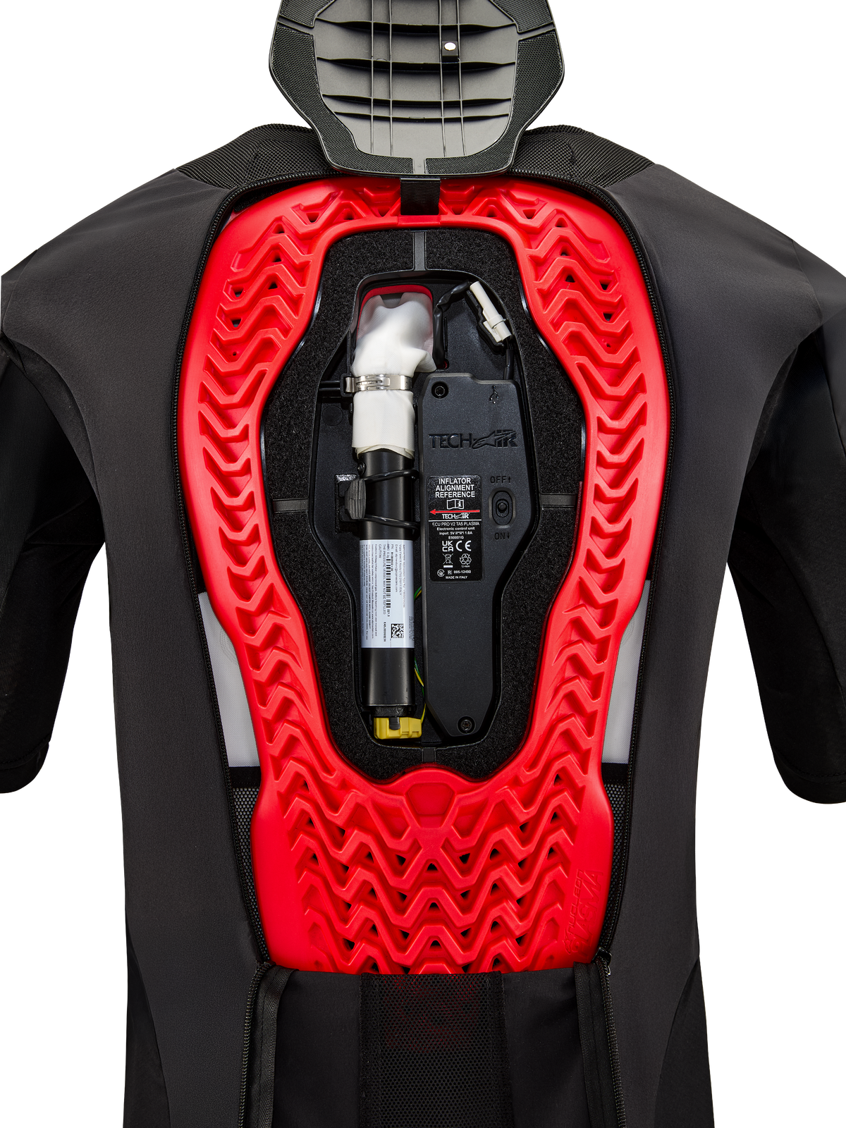 Sistema de airbag Alpinestars Tech-Air 5 Plasma, vista interna que muestra el cartucho de repuesto negro instalado y la unidad de control electrónica, integrados en un protector de espalda Nucleon Plasma rojo brillante dentro de un chaleco protector negro