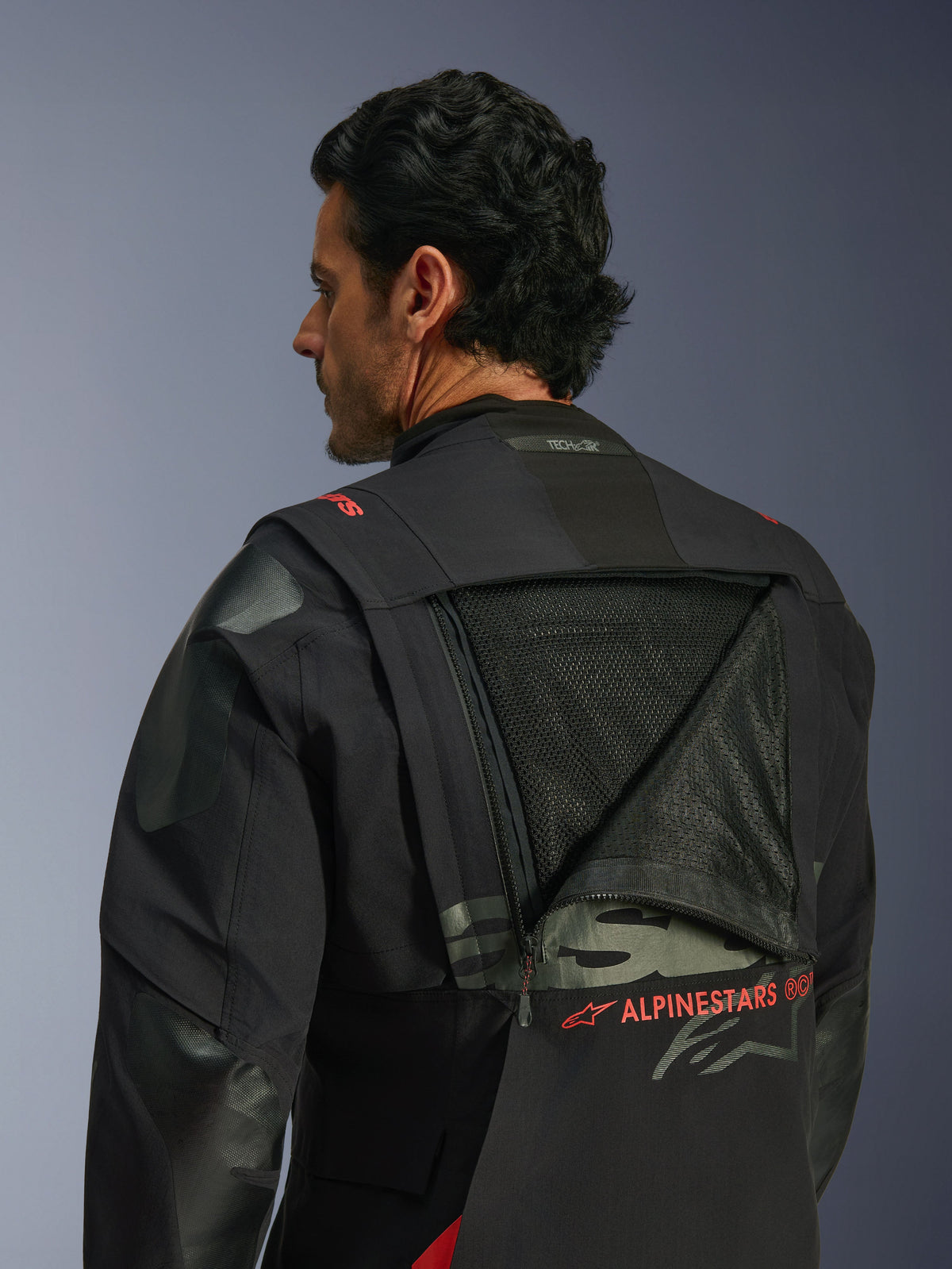 Alpinestars Halo Pro Drystar® XF Laminated Jacket, chaqueta de moto de aventura, Black Dark Shadow, vista posterior con panel de ventilación modular abierto que muestra una amplia zona de malla, logotipo Alpinestars en rojo, distintivo Tech-Air® Ready en el cuello, construcción textil resistente para conducción todoterreno.