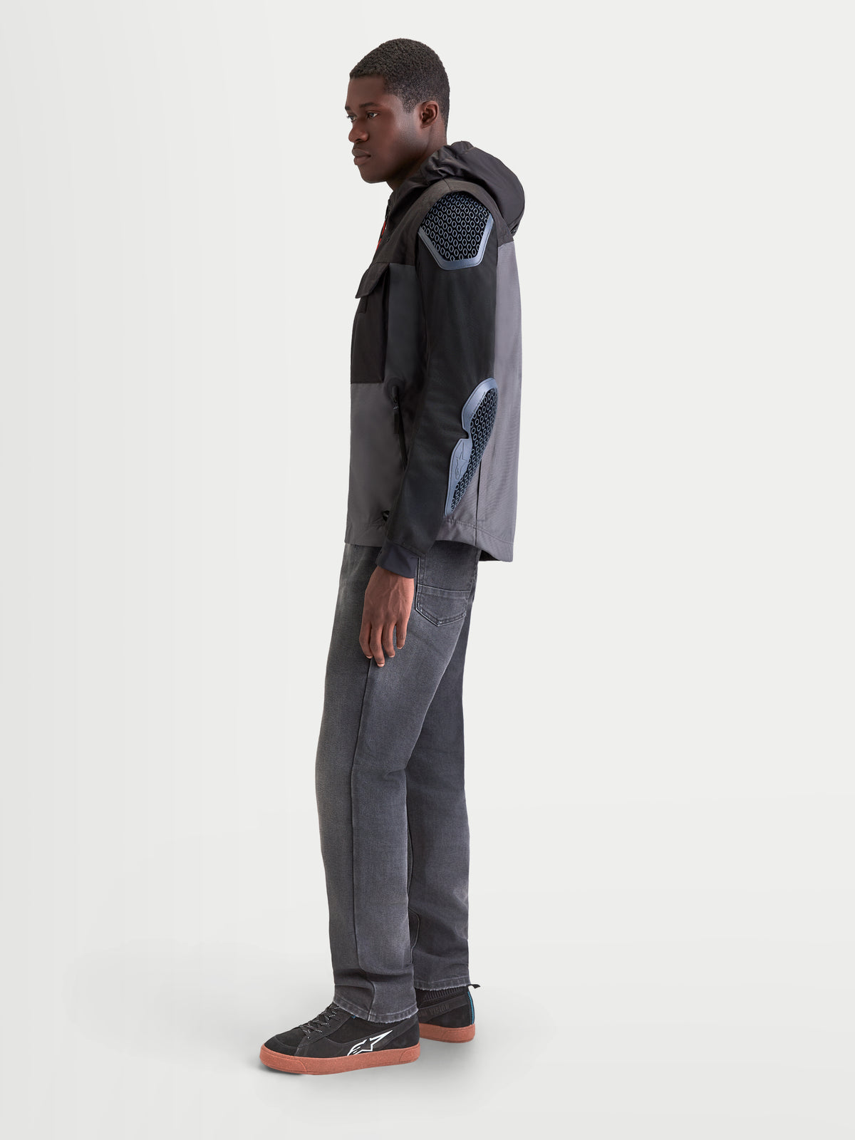 Alpinestars Morfex Parka Waterproof Jacket, men's urban contemporary motorcycle jacket in lunar gray and black, side profile view on a model wearing the textile waterproof parka with integrated hood.