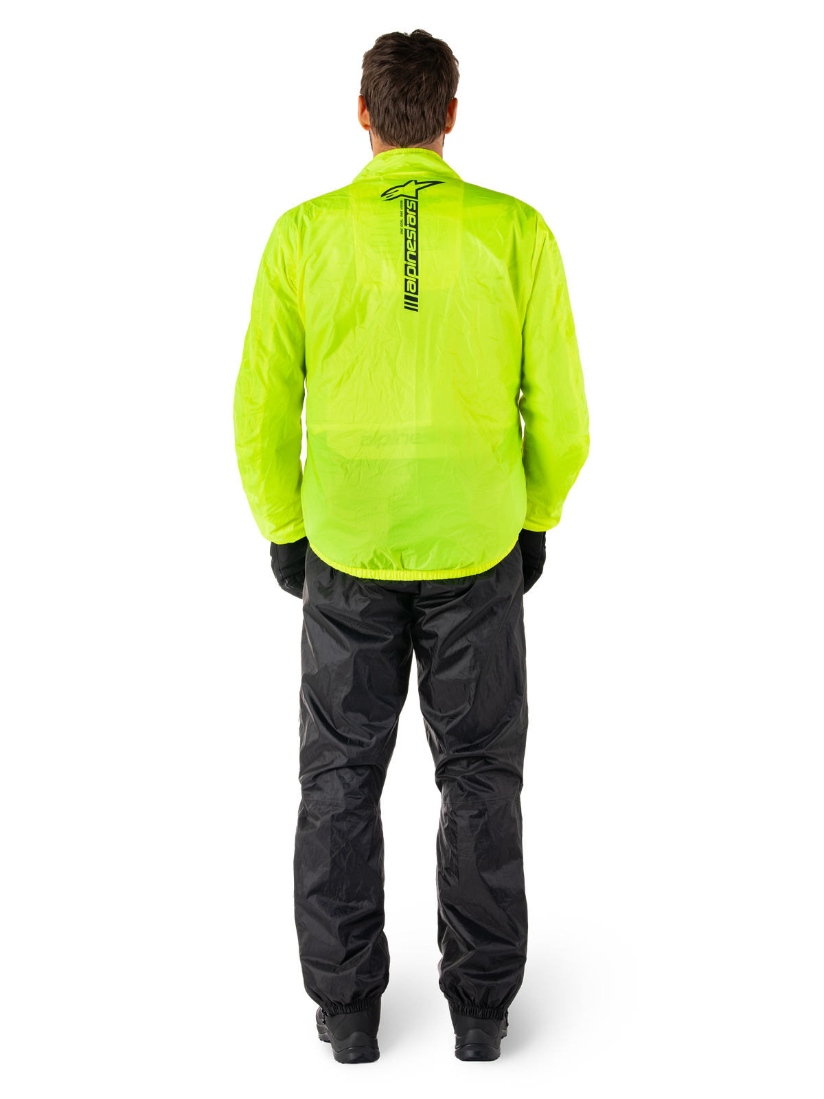 Chaqueta y pantalones Alpinestars Hurricane Rain V2, traje de lluvia impermeable para moto, chaqueta amarillo flúor brillante con marca negra vertical en la espalda, pantalones negros, material textil ligero diseñado para protección en climas húmedos