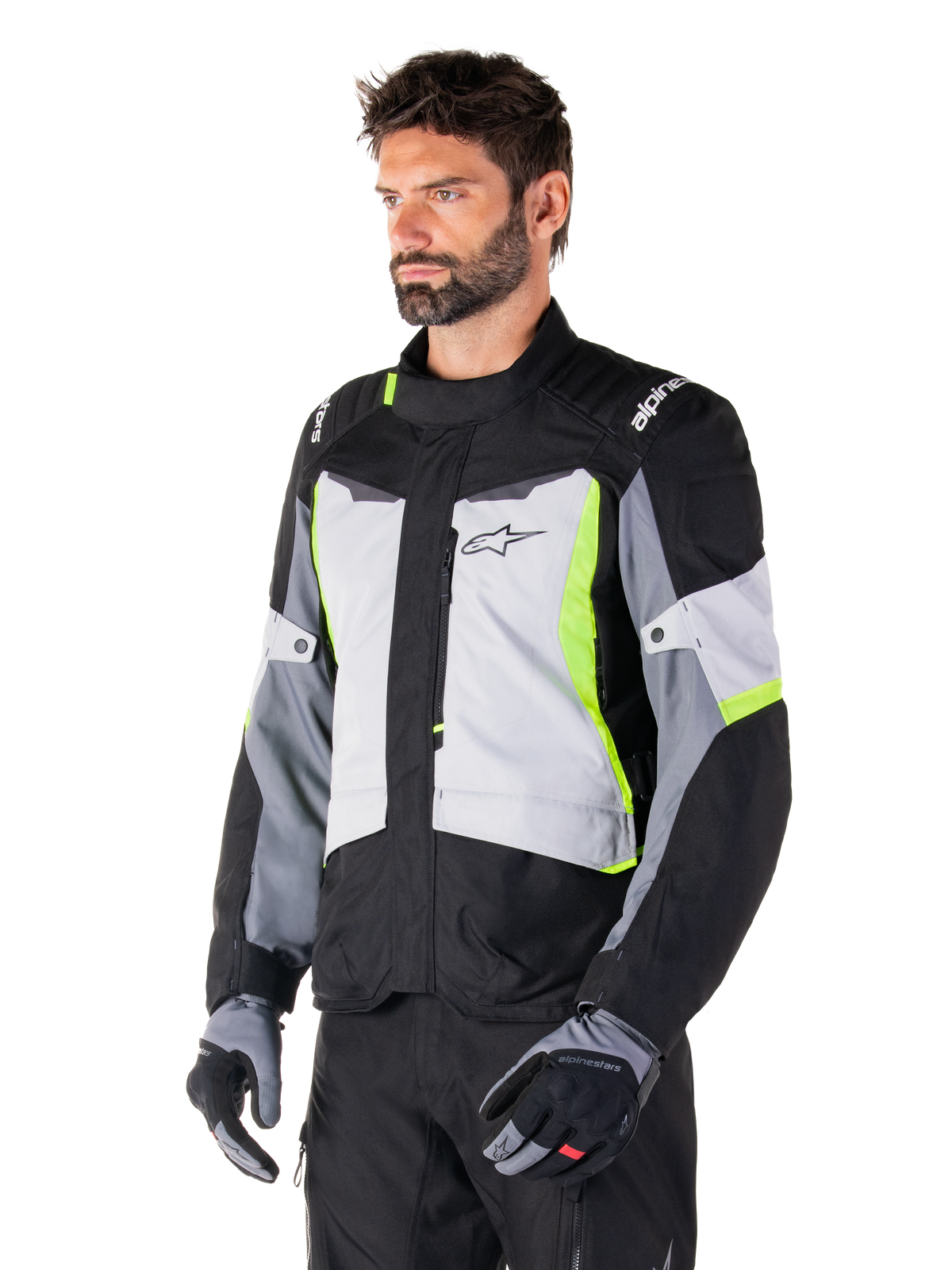 Alpinestars ST-1 Waterproof Jacket, Ice Gray Black Yellow Fluo, worn by a man with matching gloves and black pants, featuring gray torso panels with fluorescent yellow accents, black shoulders with white branding, adventure touring design for road riding
