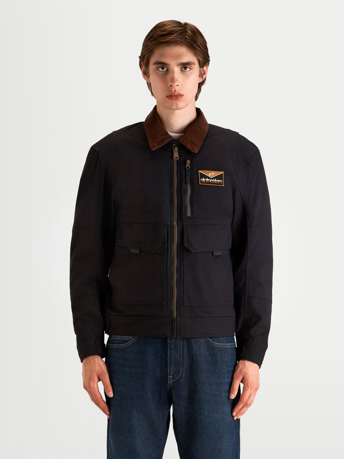 Alpinestars Mustang Waterproof Chaqueta, chaqueta de moto urbana contemporánea para hombre en color antracita oscuro y marrón oscuro, vista frontal en un modelo que muestra la construcción de sarga elástica de estilo workwear y el cuello de pana