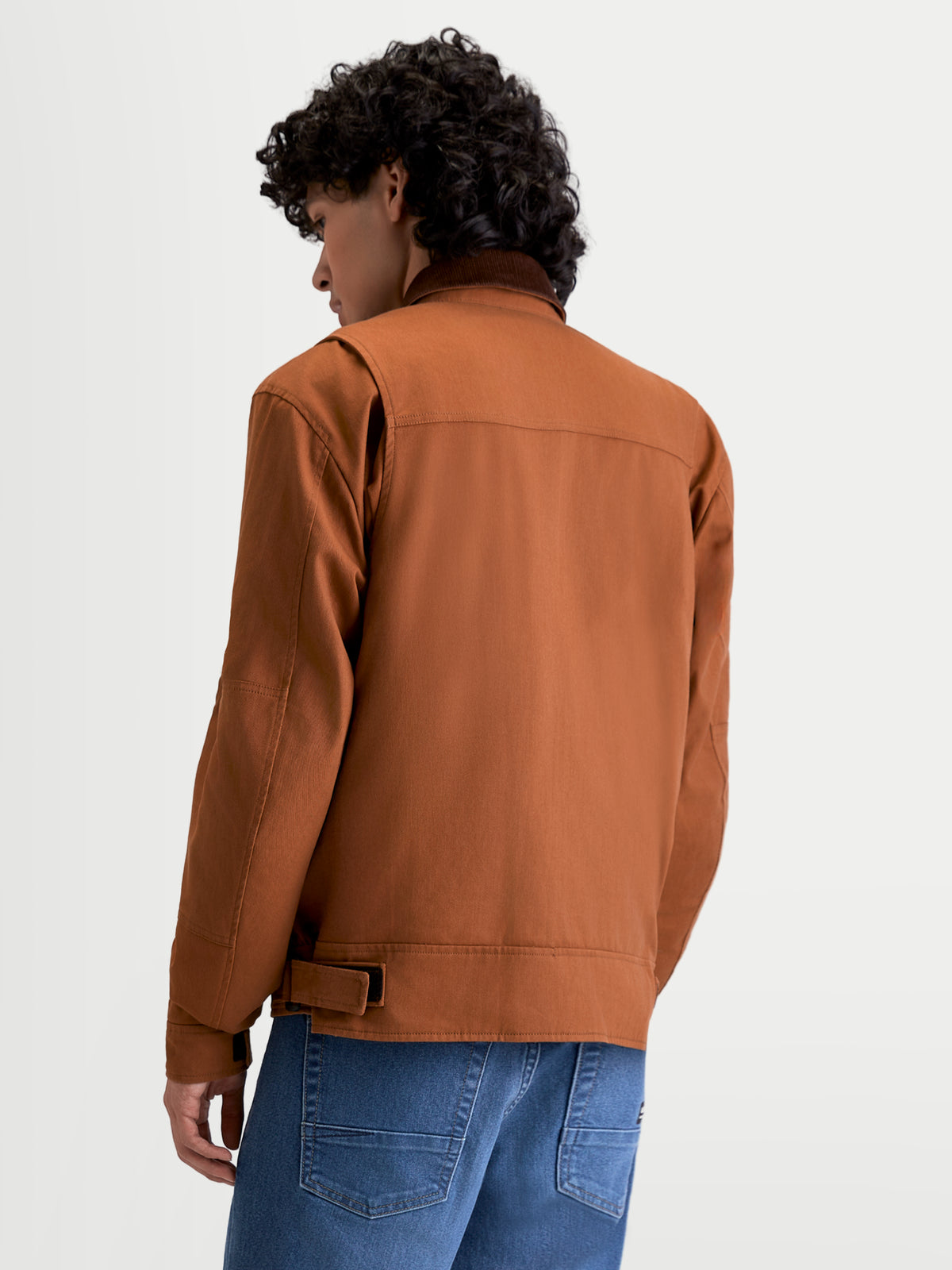 Alpinestars Mustang Waterproof Jacket, men's urban contemporary motorcycle jacket in dark rust and dark brown, rear three-quarter view on a model showing workwear-styled stretch twill construction and shoulder gusset details