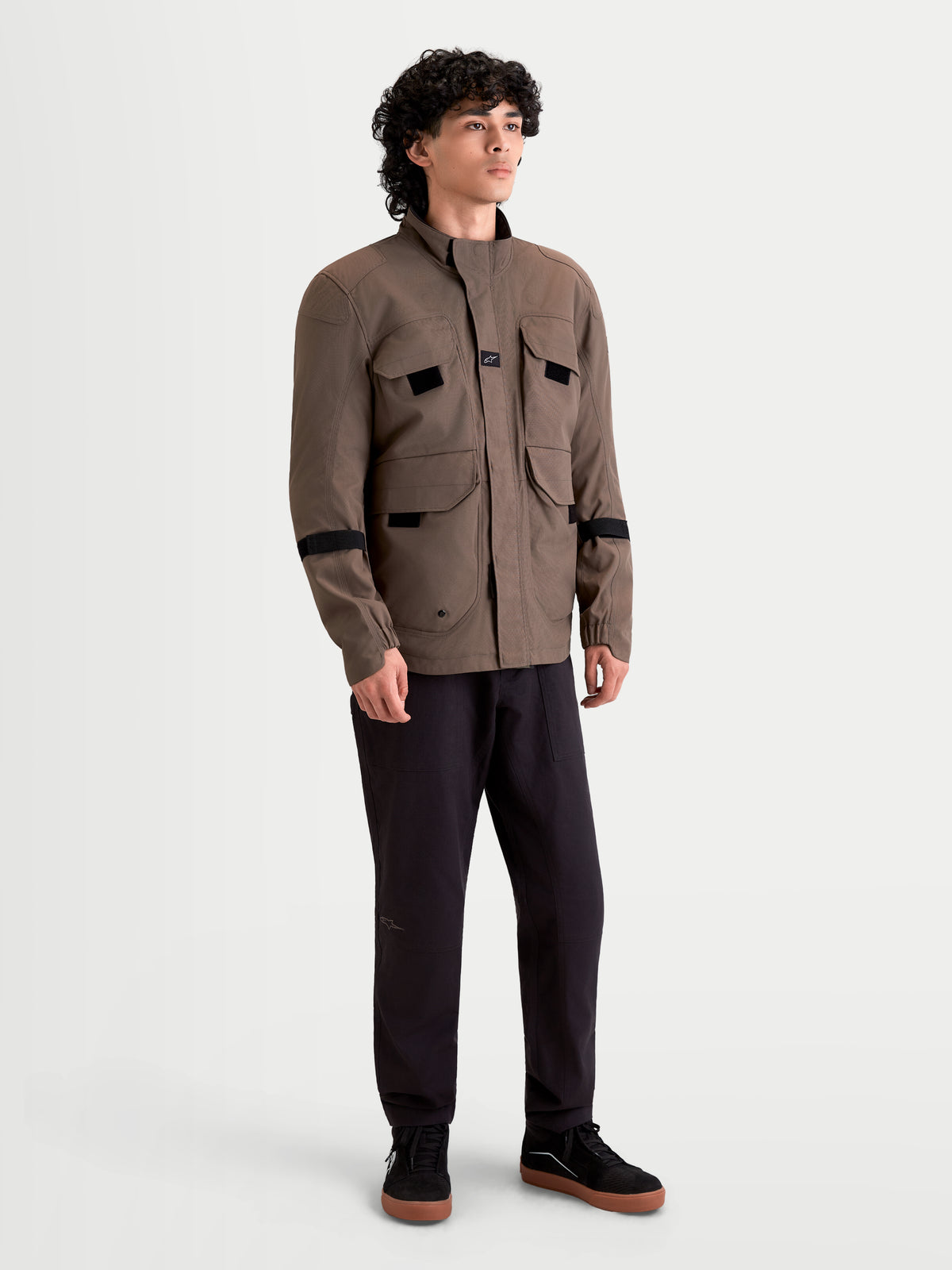 Alpinestars Altan Drystar Jacket, men's urban contemporary motorcycle textile jacket in walnut and black, front view on a model wearing the waterproof field-jacket style with utility cargo pockets.
