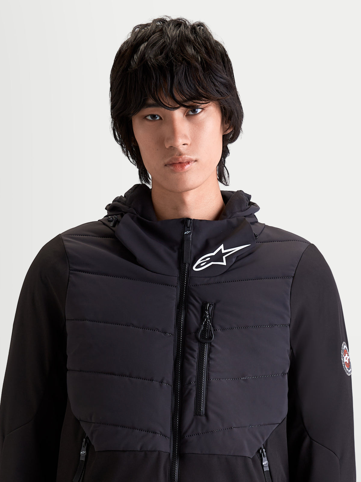 Alpinestars Therma-Tech Waterproof Jacket, men's urban contemporary motorcycle jacket in black, front view on a model showing sonic-welded down construction and integrated hood system.
