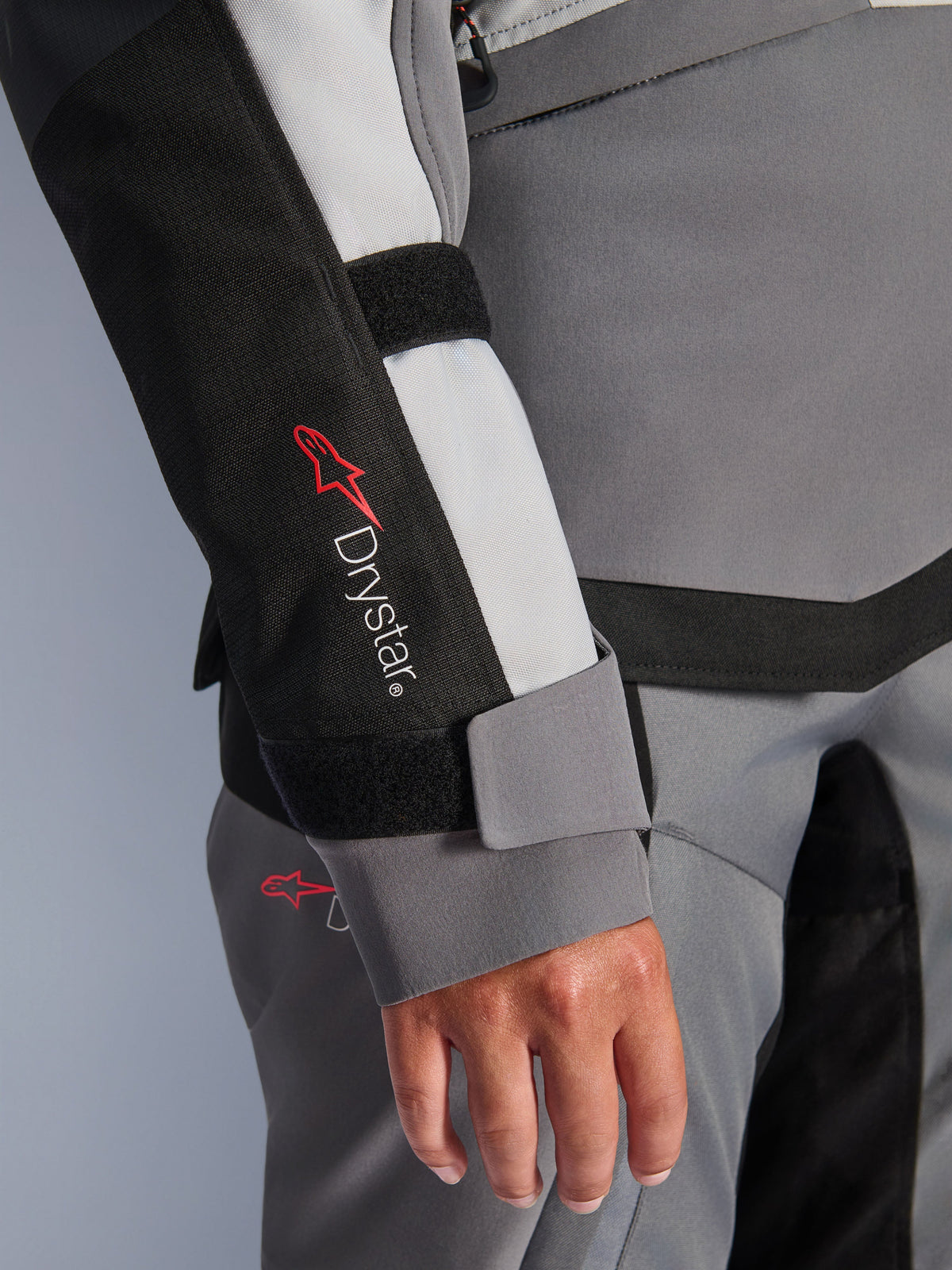 Alpinestars Stella Andes V4 Drystar® Jacket, women's gray textile adventure sleeve with logo and velcro wrist closure.