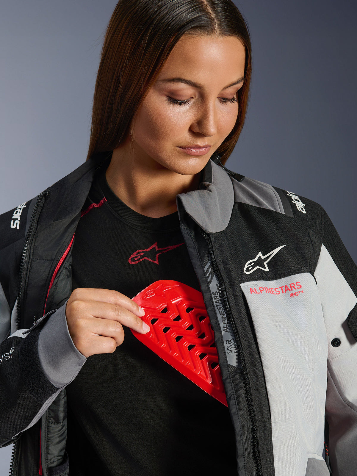 Alpinestars Stella Andes V4 Drystar® Women’s Jacket in Gray featuring a red chest armor insert for safety.