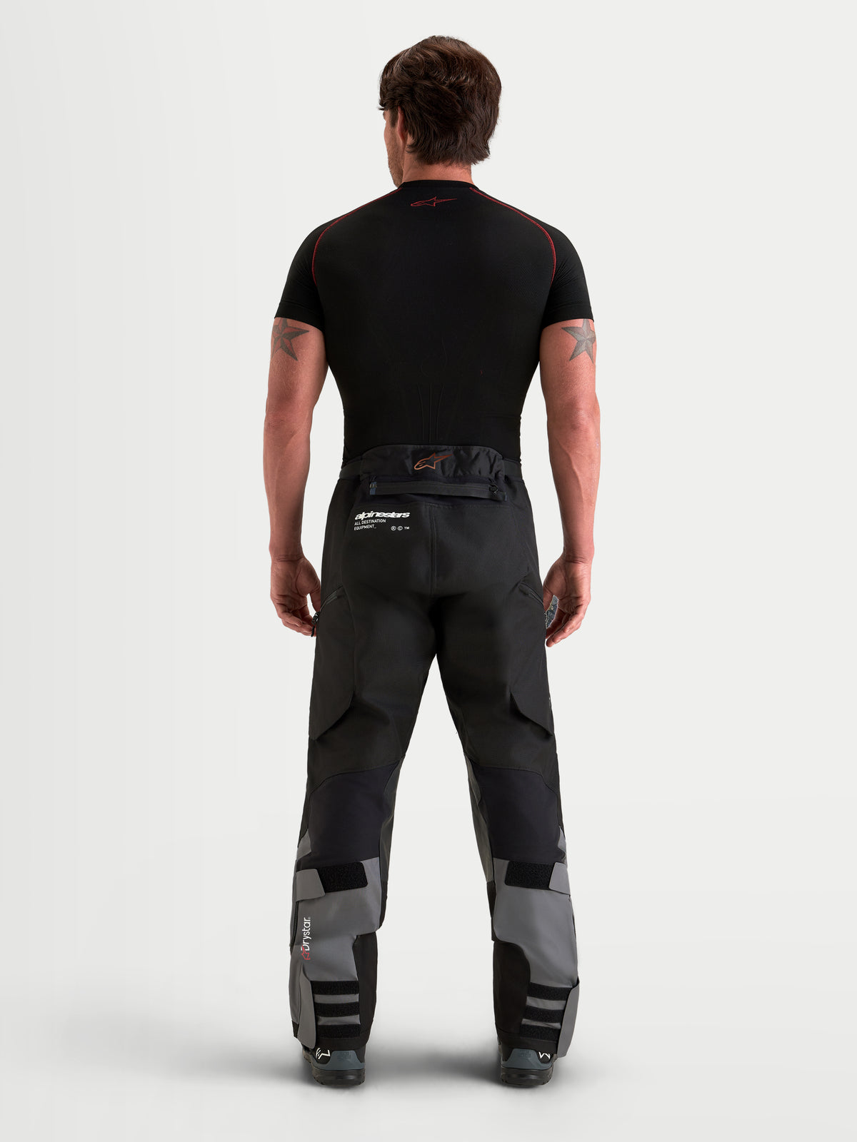 Alpinestars Harok V 2 Drystar pantalones de moto adventure para hombre, gris oscuro y negro, vista trasera que muestra la construcción ripstop y diseño sobre la bota