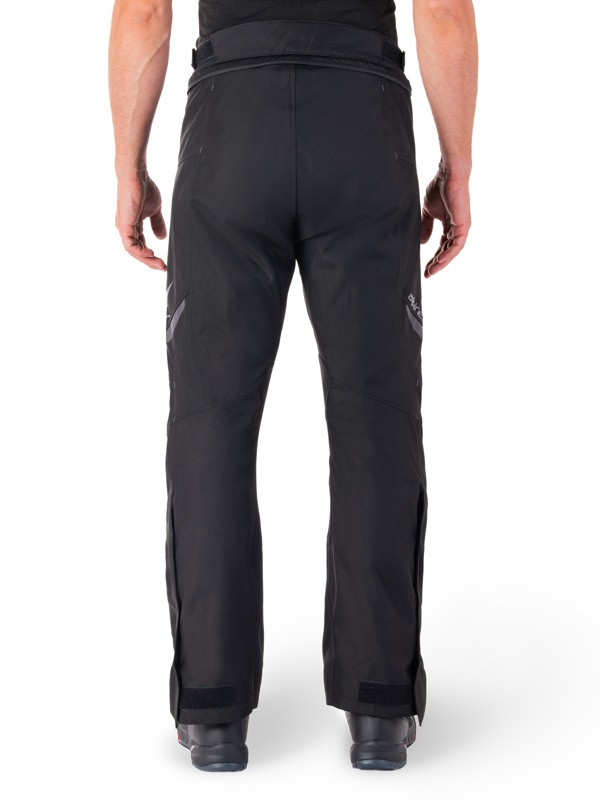 Alpinestars St-1 Waterproof Pants, Motorcycle Touring Pants, Black, back view showing reflective detailing on thighs and adjustable ankle closures, worn with black boots, minimalist design for all-weather road and adventure riding