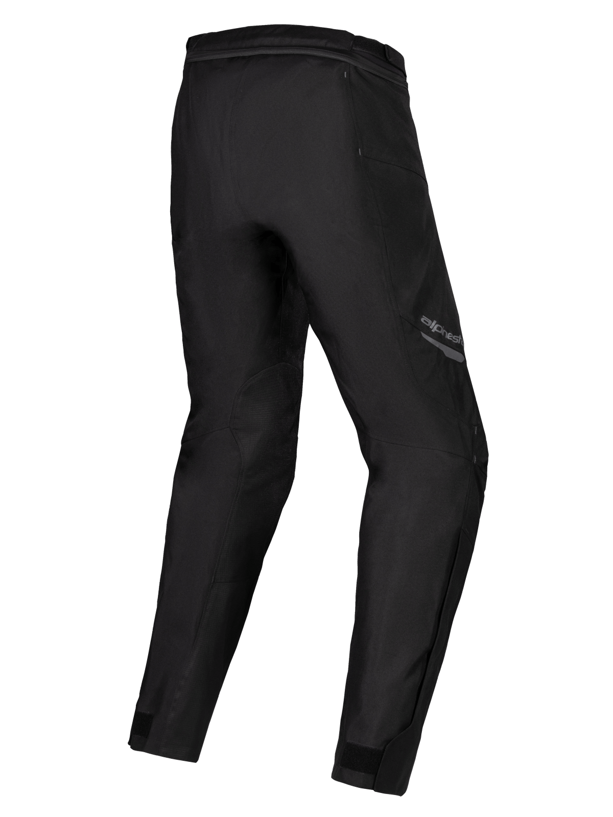 Pantalones impermeables Alpinestars Stella ST-1, pantalones de moto para mujer, negro, vista trasera de tres cuartos que muestra las piernas precurvadas, construcción textil con cremallera de conexión en la cintura y ajustadores en los tobillos, equipamiento de turismo de aventura
