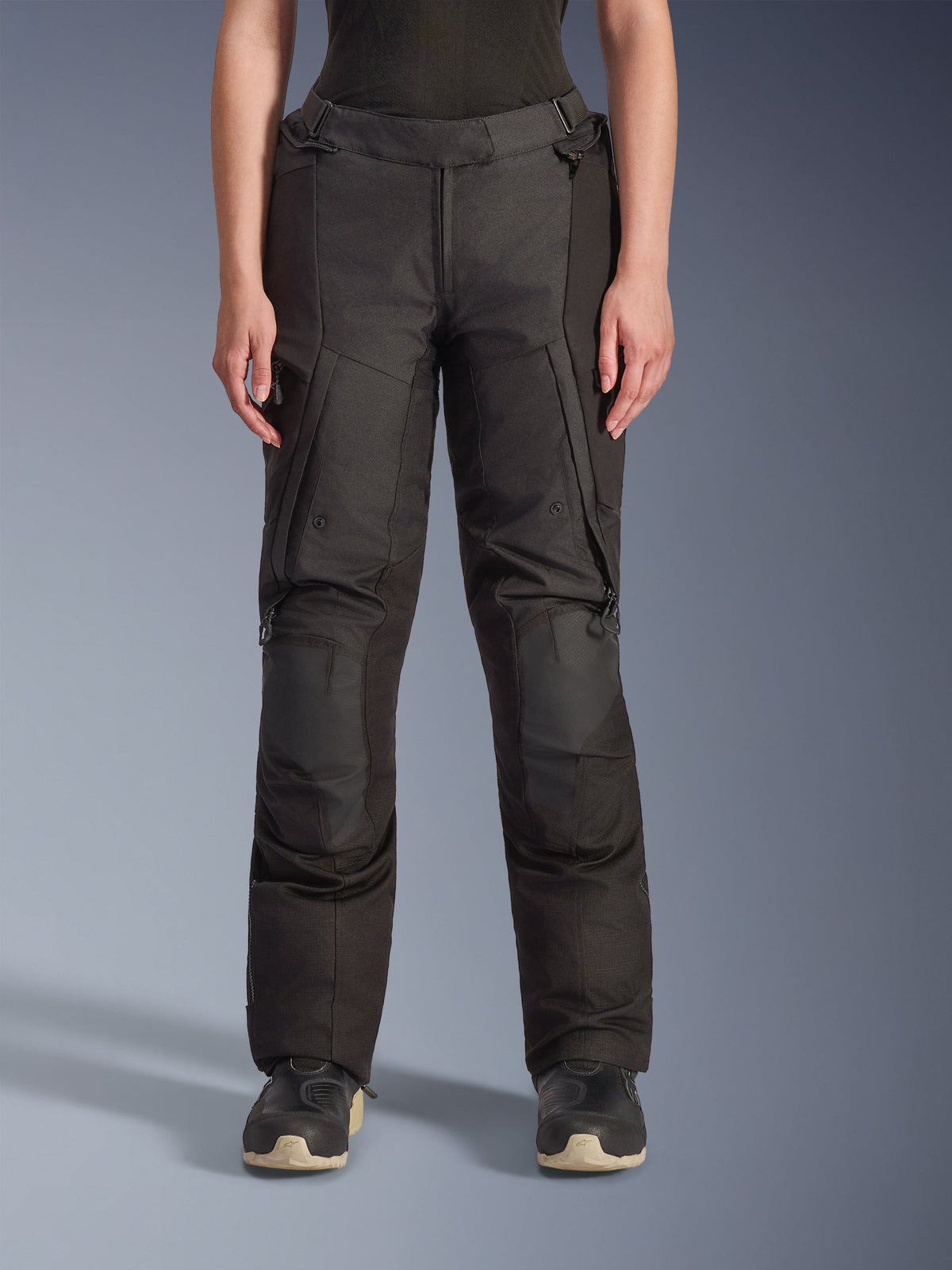 Alpinestars Stella Andes V4 Drystar Pants, Women's Adventure Touring Pants, Black, front view, featuring reinforced knee panels, water-resistant cargo pockets, and adjustable waist straps, worn with black boots in a studio setting.