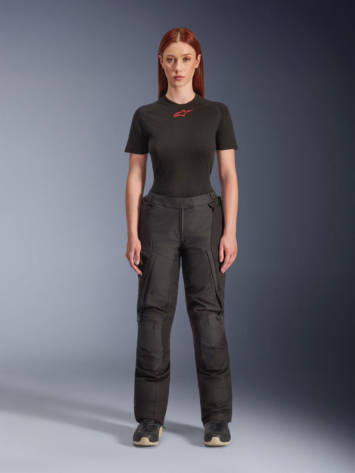 Alpinestars Stella Andes V4 Drystar® Pants, black women’s adventure touring motorcycle pants, shown on a model with a black Alpinestars t-shirt, featuring a technical textile design with cargo pockets and reinforced knee panels.