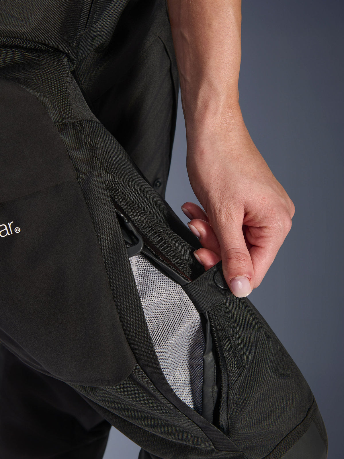 Alpinestars Woman Stella Andes V4 Drystar® Pants, Motorcycle Pants, Black, close-up of a hand opening the zippered thigh ventilation to reveal mesh lining for airflow, durable textile adventure gear