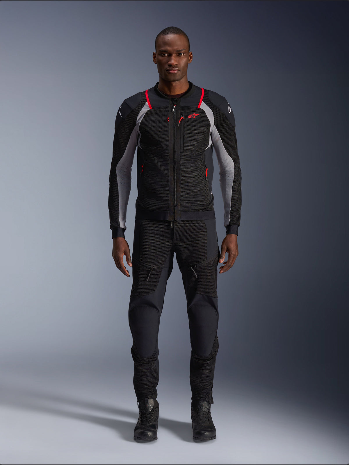 Alpinestars Troop-Air Pro Jacket, Technical Motorcycle Jacket, Black Ash Gray and Bright Red, featuring mesh panels and red accents, worn by male model with black riding pants and boots, sleek urban design with technical ventilation.