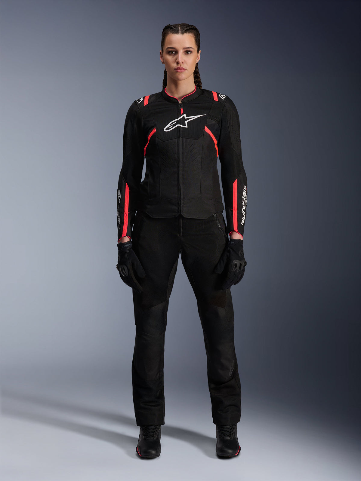 Alpinestars Stella T-SPS Air v2 Jacket, Women's Motorcycle Jacket, Black and Diva Pink, front view, white chest logo, mesh ventilation panels, worn with black pants and gloves, sleek urban riding gear