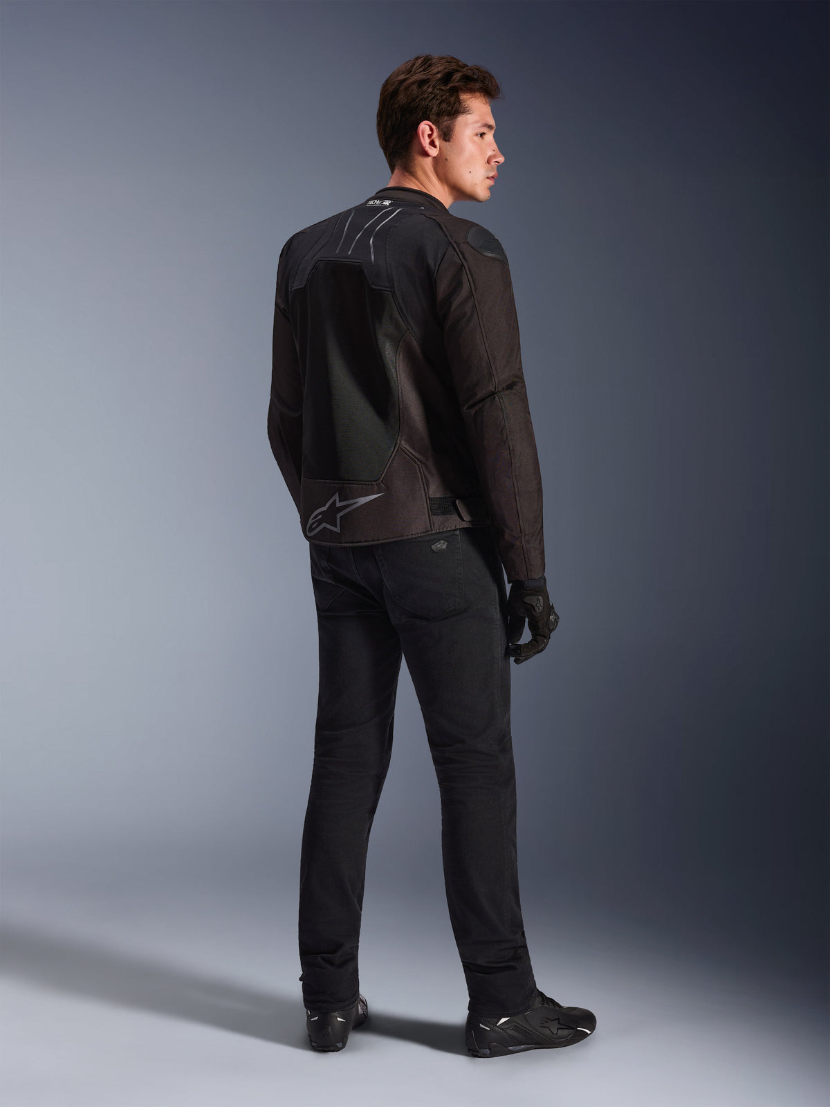 Alpinestars SMX Air Jacket in Black Anthracite, rear view on model, featuring Tech-Air® Ready branding on the collar and Astar logo on the lower back, worn with black riding pants and shoes.