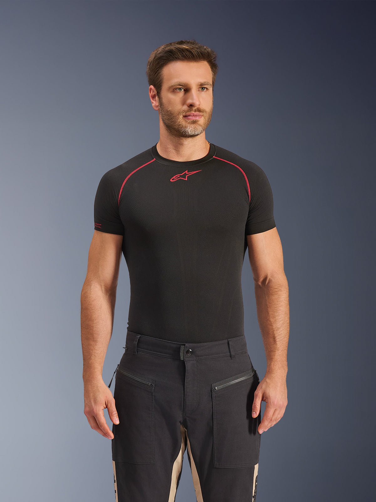Alpinestars Flex-AST Canvas Pants in Black Aluminum, urban motorcycle pants featuring a utilitarian workwear design, zippered front pockets, and contrasting tan panels on the inner legs, worn by a model with a black base layer t-shirt.