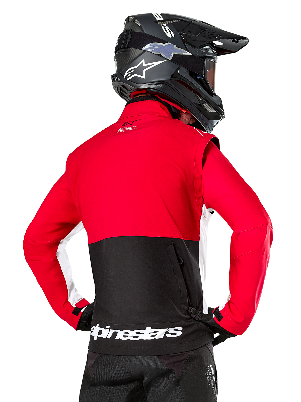 Alpinestars Lite-Dura Softshell Jacket, Black Bright Red White, back view on a motocross rider, red upper body and sleeves with black lower back panel, zippered rear storage pocket, white Alpinestars logo on the bottom hem, worn with a black helmet and pants
