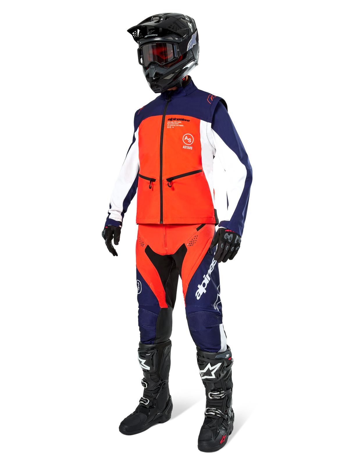 Motocross rider wearing the Alpinestars Lite-Dura Softshell Jacket in Navy Hot Orange and White, complete with matching off-road pants, black helmet with goggles, and black racing boots, coordinated enduro gear set