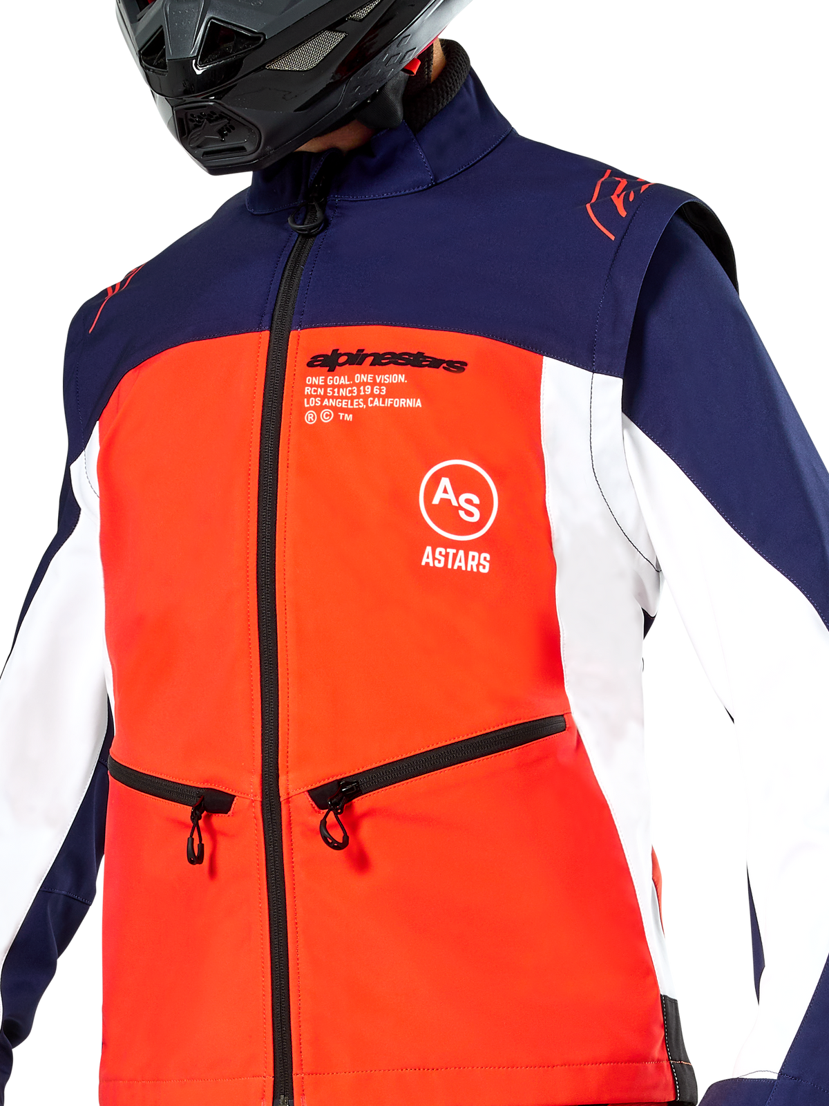 Alpinestars Lite-Dura Softshell Jacket in Navy Hot Orange and White, close-up view of the torso, featuring a bright orange front panel with white side panels and navy blue shoulders, zippered hand pockets, and prominent Alpinestars branding, worn by a rider with a black off-road helmet.
