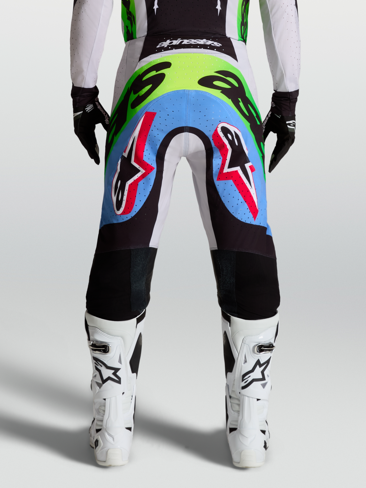 Pantalones Alpinestars Supertech Dyna para motocross de hombre, lila y verde flúor, con paneles perforados, vista trasera