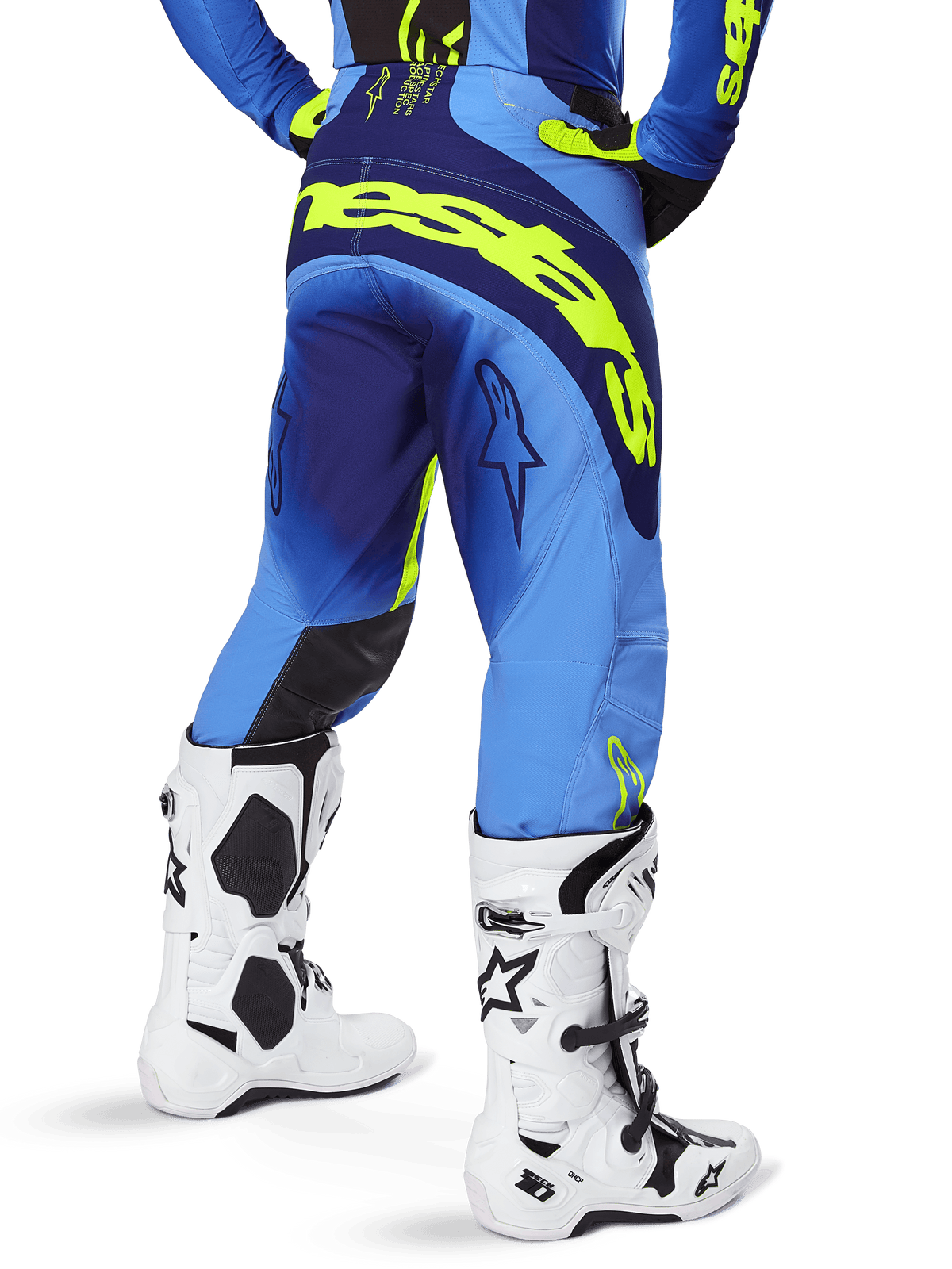 Alpinestars 2025 Techstar Melt Pants, Motocross Pants, Yellow Fluo Blue, rear view featuring large yellow branding across the seat and dark blue accents, worn with white Alpinestars Tech 10 boots and a matching jersey.